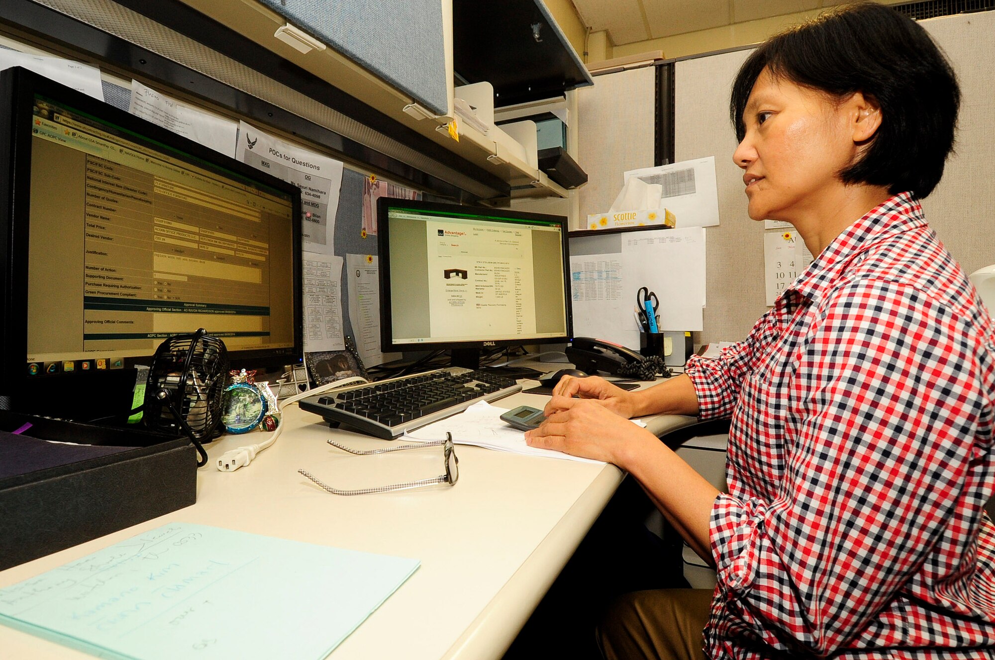 Ms. Adora Herrera, 18th Contracting Squadron agency/organization program coordinator, verifies the information on a single purchase limit increase form during the soft close-out at Kadena Air Base, Japan, Sept. 19, 2014. Funds are postured in case additional money is received by the squadron during the soft close out. There are four flights in 18 CONS and Herrera is part of "P Flight" where all Government Purchase Card purchases get approved. (U.S. Air Force Photo by Staff Sgt. Darnell T. Cannady/Released) 