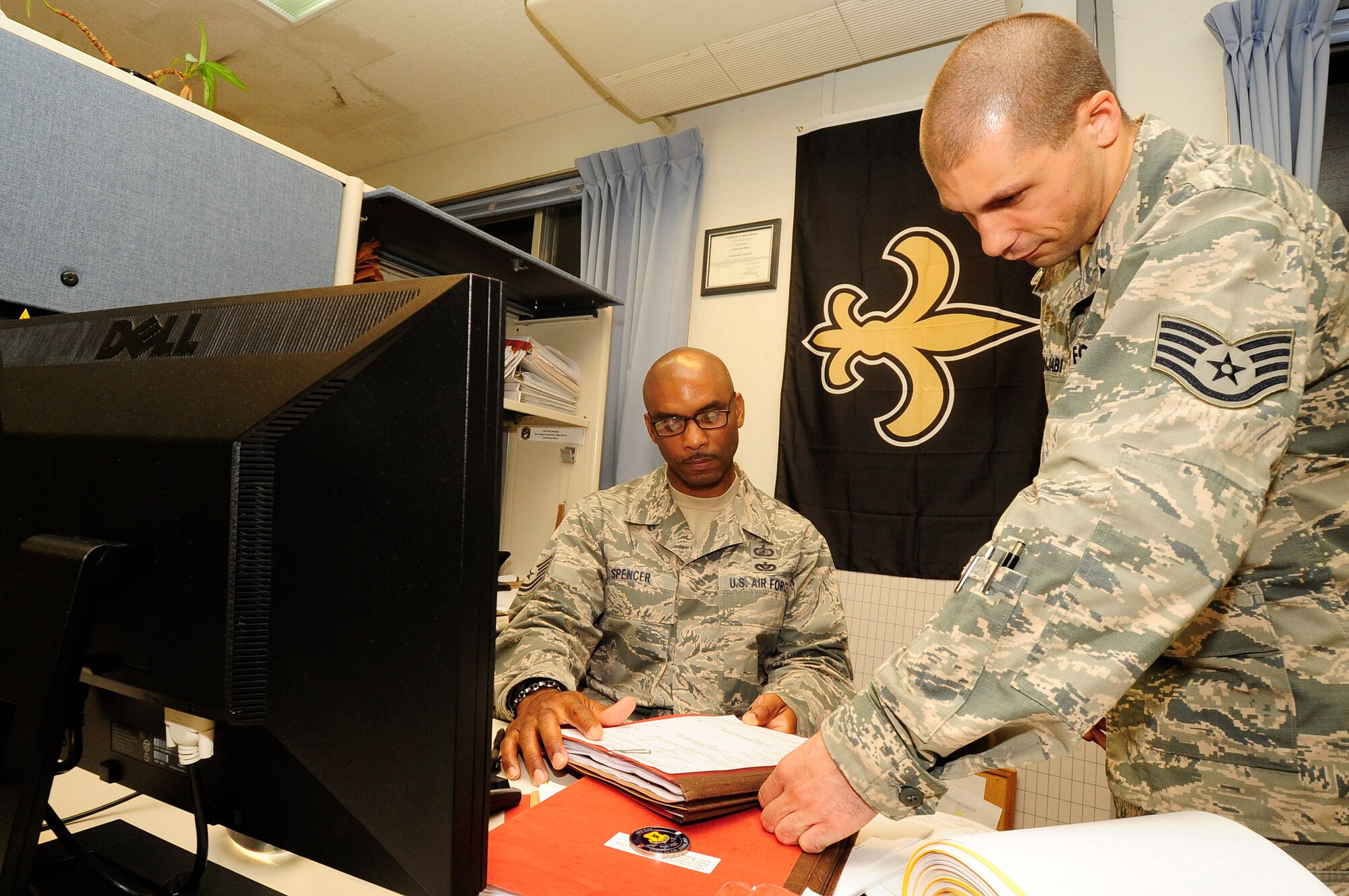 U.S. Air Force Tech. Sgt. Gus Spencer, 18th Contracting Squadron contracting officer, gives reviews comments on a contract to Staff Sgt. Eric Punjabi, 18th Contracting Squadron contracting officer, during the soft close-out at Kadena Air Base, Japan, Sept. 19, 2014. During soft close-out, squadrons make sure that all funds are obligated and make plans in case they receive additional money. Both members are part of "C Flight" who buys construction contracts for the entire base. (U.S. Air Force Photo by Staff Sgt. Darnell T. Cannady/Released) 