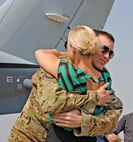 A MC-12W Liberty pilot is greeted by his spouse after returning in the final MC-12 from Kandahar Airfield, Afghanistan, to Beale Air Force Base, Calif., Sept. 22, 2014. Since May 2010 the MC-12W Liberty has supported Operation Enduring Freedom providing real-time intelligence, surveillance, and reconnaissance directly supporting ground forces. (U.S. Air Force photo by Airman 1st Class Ramon A. Adelan/Released)