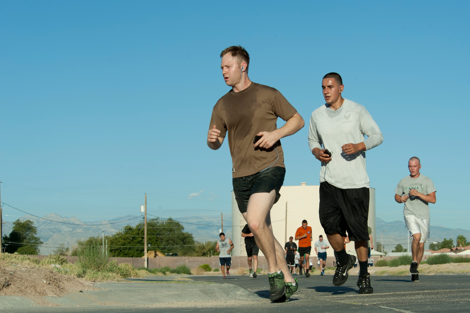Runners reach the last leg of the Air Force birthday 5k run in front of the Warrior Fitness Center, Nellis AFB, Nev., Sept. 18, 2014. The event was in celebration of the Air Force’s 67th birthday. (U.S. Air Force photo by Senior Airman Timothy Young)