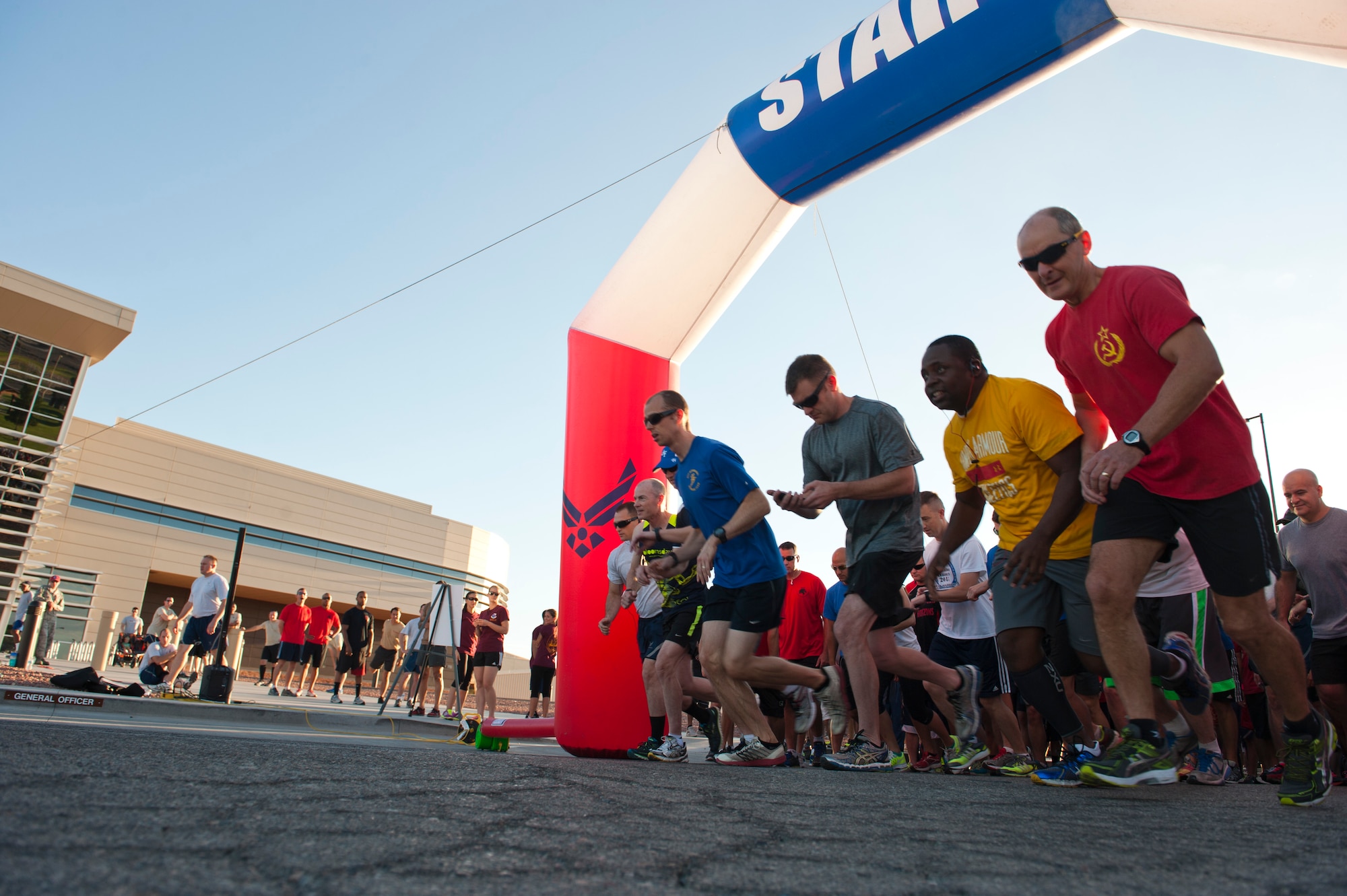Airmen from Nellis Air Force Base begin the Air Force 67th birthday 5K run in front of the Warrior Fitness Center, Nellis AFB, Nev., Sept. 18, 2014. The Air Force was established as an independent branch of the armed forces on Sept. 18, 1947. (U.S. Air Force photo by Airman 1st Class Thomas Spangler)