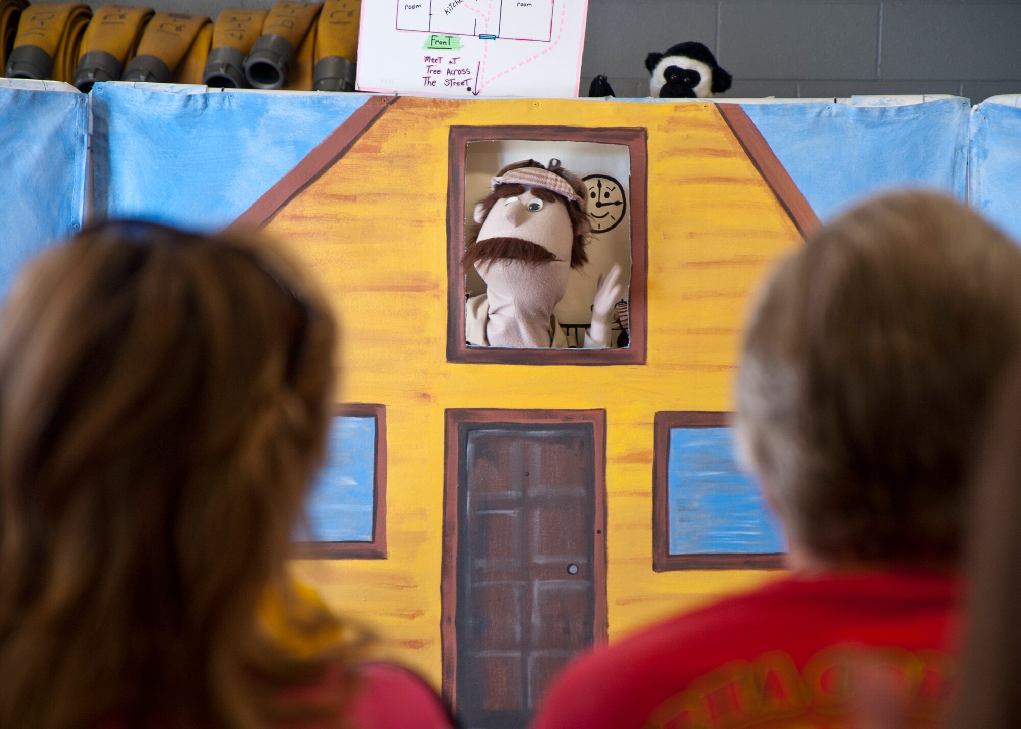 Children watch a puppet show put on by the 90th Civil Engineer Squadron Sept. 20, 2014, at the Fire Department’s annual open house. Puppet shows are the most effective way to share information about fire safety with younger kids, said Gregory Chesser, 90th CES Assistant Fire Chief. (U.S. Air Force Photo by Airman Malcolm Mayfield)
