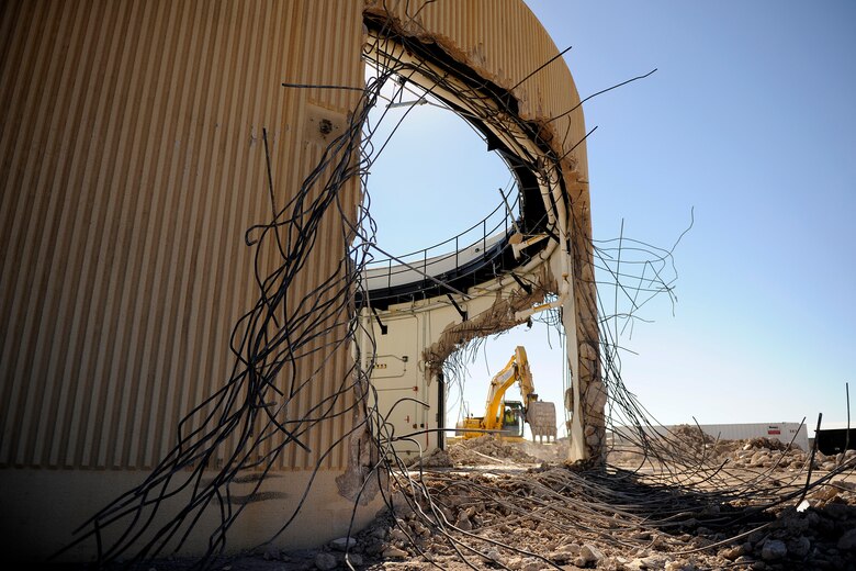 Demolition crews dismantle an antenna building Sept. 19, 2014 at the Colorado Tracking Station on Schriever Air Force Base, Colo. The 22nd Space Operations Squadron will officially decommission the tracking station, known as PIKE, during a ceremony Sept. 29, 2014. (U.S. Air Force photo/Dennis Rogers)