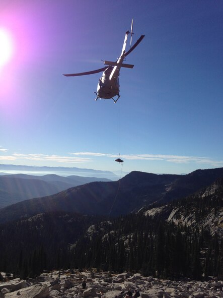 Ammi Midstokke is being hoisted onto a UH-1N Iroquois helicopter from the 36th Rescue Flight near Priest Lake, Idaho, Sept. 20., 2014 It took a combination and teamwork of and eight-man ground team and a four-man crew from Fairchild to complete the rescue mission. (Courtesy photo/Jason Luthy)