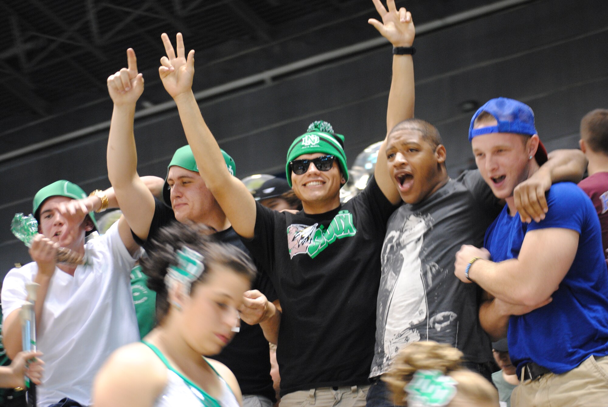Airmen from Grand Forks Air Force Base, N.D., celebrate and cheer after the University of North Dakota football team scored their first touchdown against the Stony Brook University Seawolves, Sept. 20, 2014 and the Alerus Center in Grand Forks, N.D. Service members and their families were treated to free game as part of the 17th Annual Maury Rothkopf Military Appreciation Day, which was sponsored by UND and the Grand Forks and East Grand Forks, Minn., Chambers of Commerce. (U.S. Air Force photo/Staff Sgt. Luis Loza Gutierrez)
