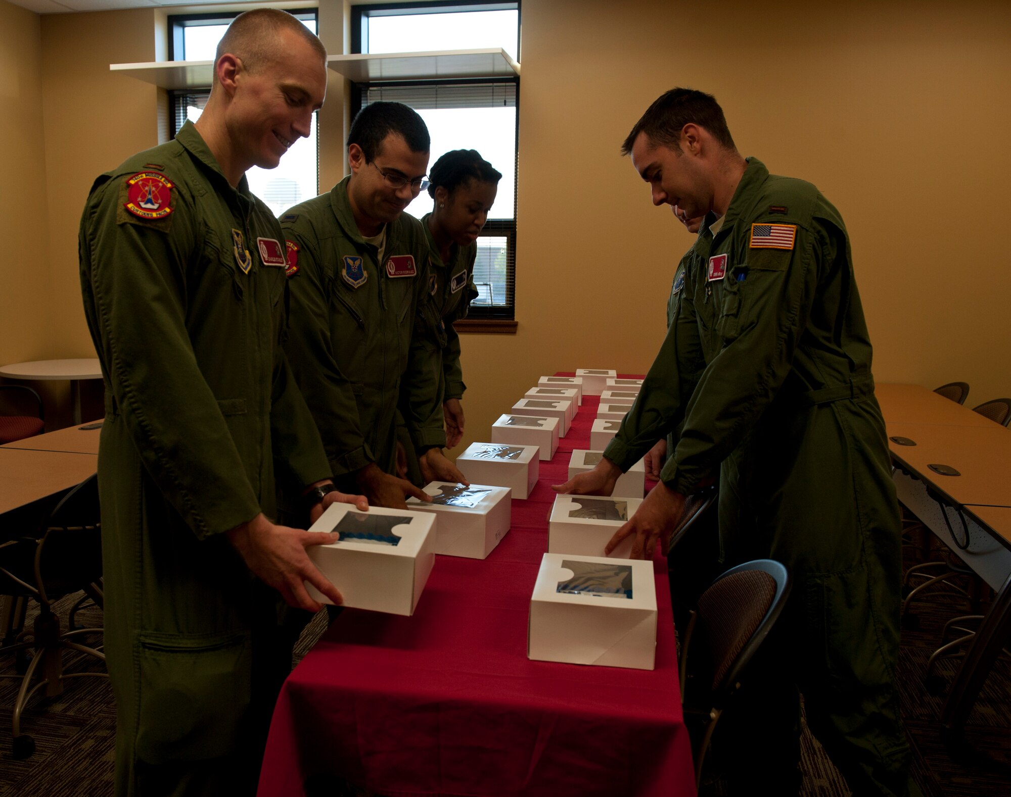 Members from the 740th Missile Squadron pickup cakes to deliver to the Missile Alert Facilities on Minot Air Force Base, N.D., Sept. 18, 2014. The 5th Force Support Squadron purchased 15 cakes to be taken to the Missile Alert Facility Airmen so they could join in the day’s celebration. (U.S. Air Force photo/Senior Airmen Malia Jenkins)