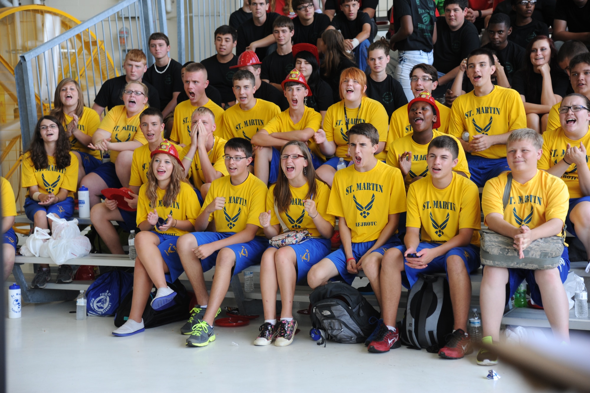 Junior ROTC students from St. Martin High School cheer for their fellow student as they compete in the pull-up competition during the STEM (science, technology, engineering and mathematics) Diversity Outreach Day Sept. 19, 2014, at the fuel cell hangar, Keesler Air Force Base, Miss.  The event consisted of 10 Mississippi gulf coast high school JROTC units visiting informative booths about Air Force opportunities and accession requirements with an emphasis on STEM.  (U.S. Air Force photo by Kemberly Groue)