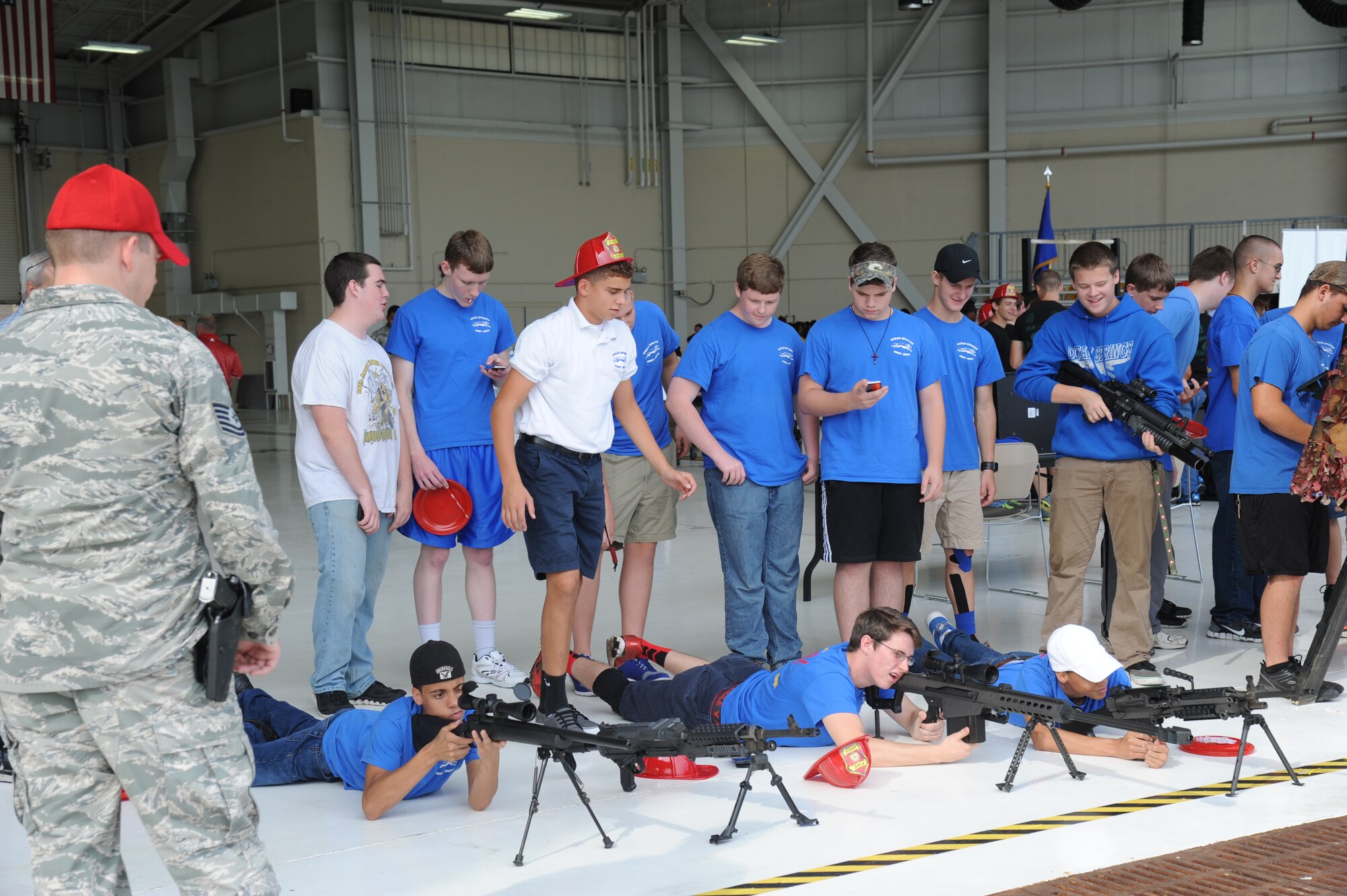 Junior ROTC students from Ocean Springs High School, Miss., check out weapons on display while visiting the 81st Security Forces Squadron combat arms booth during the STEM (science, technology, engineering and mathematics) Diversity Outreach Day Sept. 19, 2014, at the fuel cell hangar, Keesler Air Force Base, Miss.  The event consisted of 10 Mississippi gulf coast high school JROTC units visiting informative booths about Air Force opportunities and accession requirements with an emphasis on STEM.  (U.S. Air Force photo by Kemberly Groue)