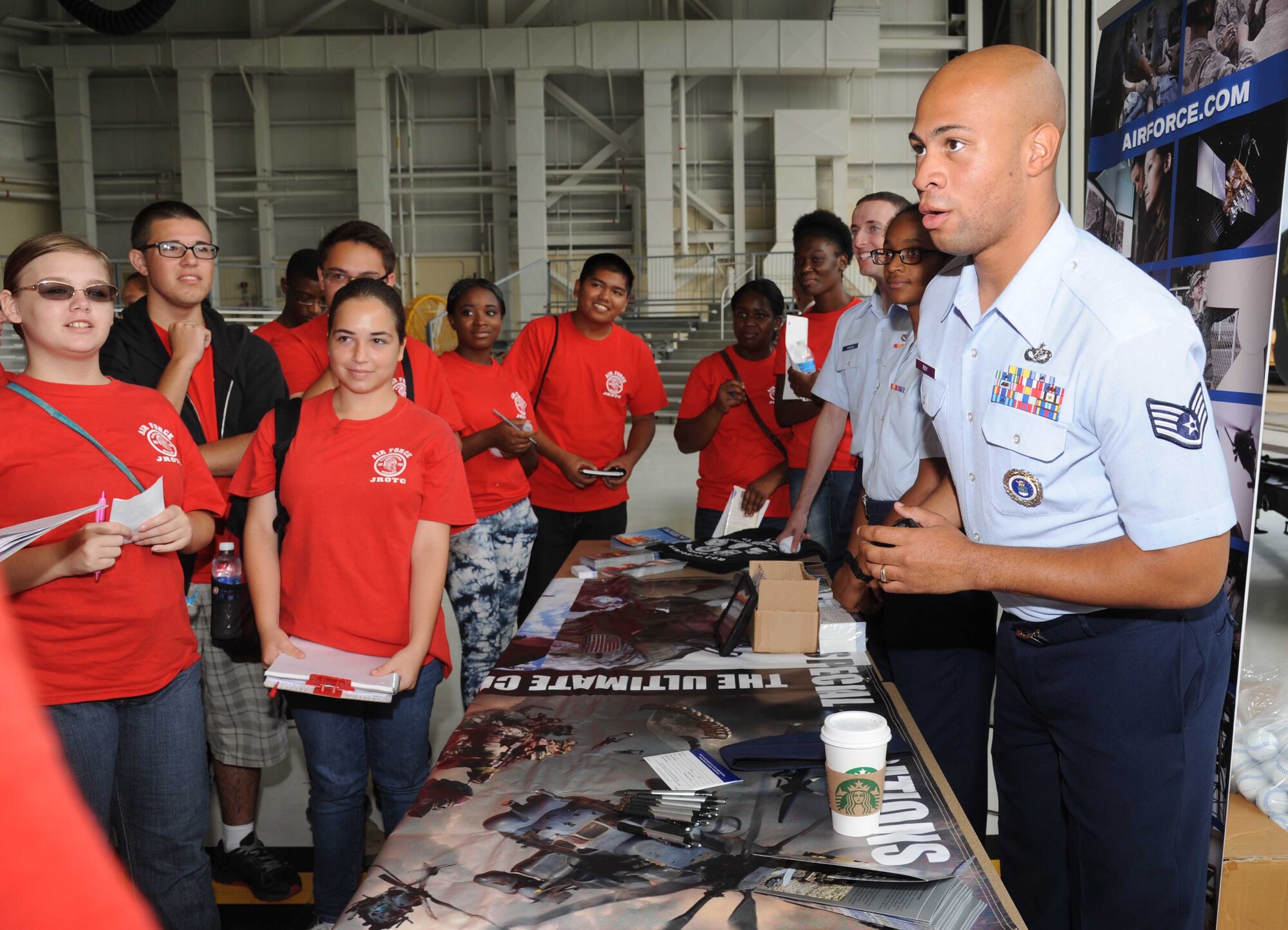 Staff Sgt. Clifford Roy, local recruiter from the 331st Recruiting Squadron, Maxwell Air Force Base, Ala., provides information at an Air Force recruitment booth to Biloxi High School Junior ROTC students during the STEM (science, technology, engineering and mathematics) Diversity Outreach Day Sept. 19, 2014, at the fuel cell hangar, Keesler Air Force Base, Miss.  The event consisted of 10 Mississippi gulf coast high school JROTC units visiting informative booths about Air Force opportunities and accession requirements with an emphasis on STEM.  (U.S. Air Force photo by Kemberly Groue)