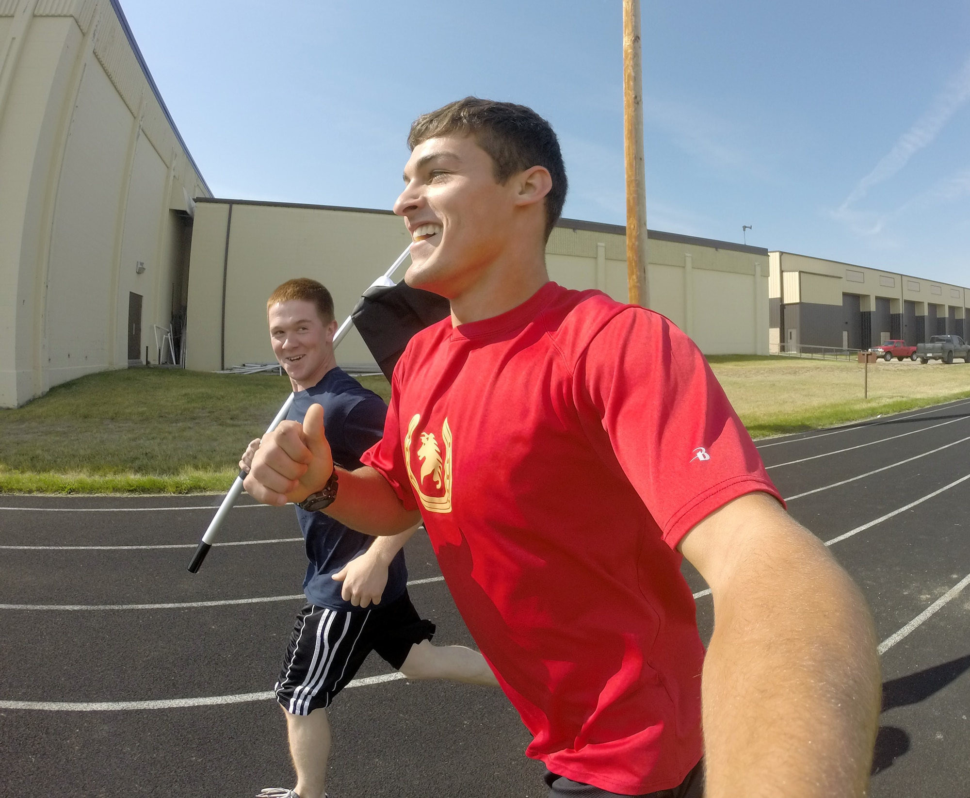 Senior Airman Ashton Sandman and Airman 1st Class Tanner Weidner, 819th RED HORSE pavement and equipment operators, run around the Malmstrom Air Force Base track as part of the Prisoner of War/Missing in Action Remembrance Run Sept. 17. Runners ran in teams for a 24-hour period to help raise awareness in the community. (U.S. Air Force photo/ Senior Airman Ashton Sandman)