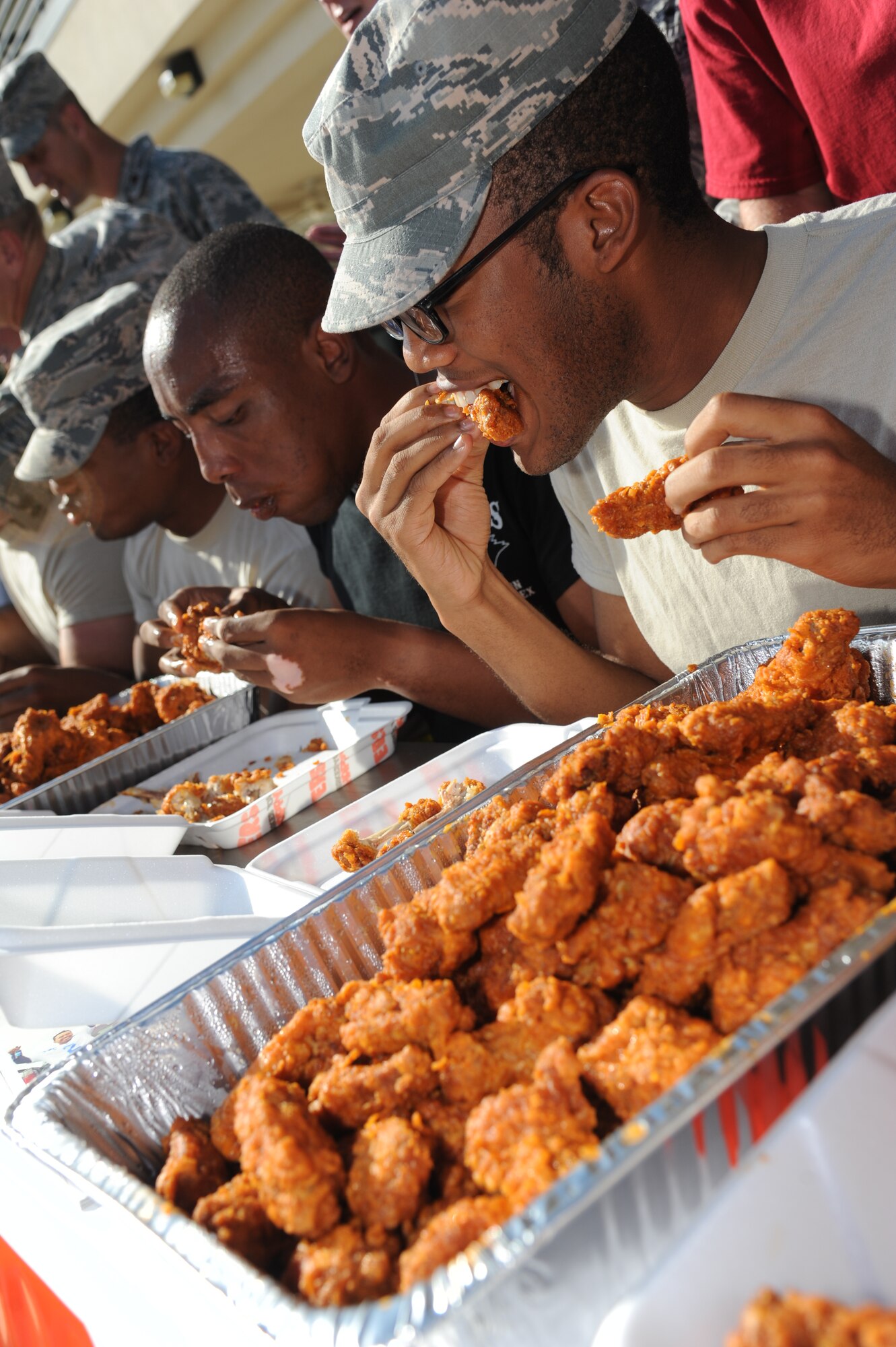 Airman Basic Jeremiah Knowles, 338th Training Squadron, competes in the hot wing eating contest during the Air Force’s 67th birthday celebration Sept. 19, 2014, Keesler Air Force Base, Miss. The event also included a cake cutting ceremony, music, games, contests and food. (U.S. Air Force photo by Kemberly Groue)