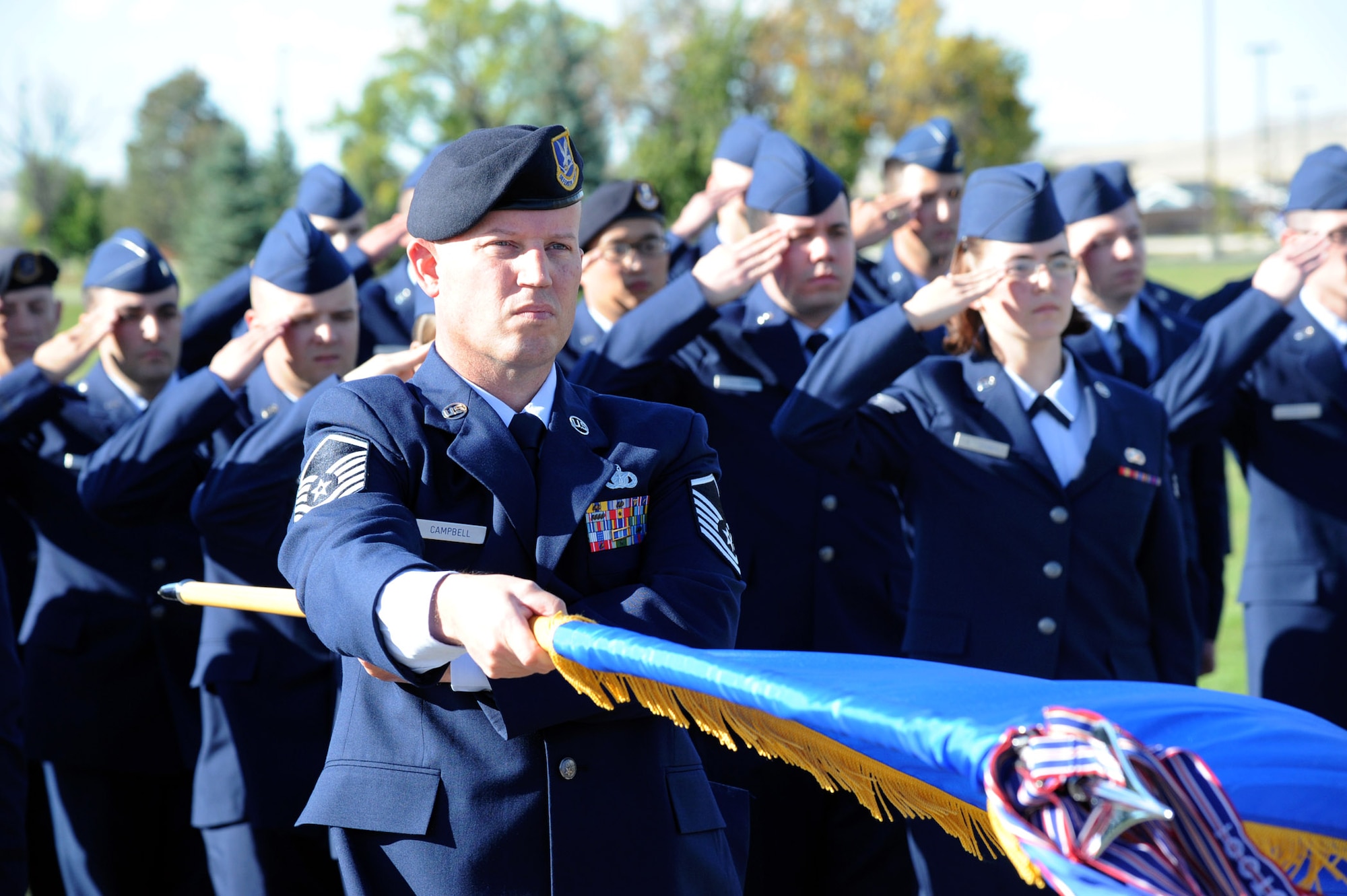 Master Sgt. Dale Campbell, 341st Security Support Squadron first sergeant, presents arms with other Airmen at Malmstrom Air Force Base during a retreat ceremony Sept. 19. The Prisoner Of War/Missing in Action recognition retreat ceremony was held at the Medal of Honor Park on base. (U.S. Air Force photo/Airman 1st Class Joshua Smoot)