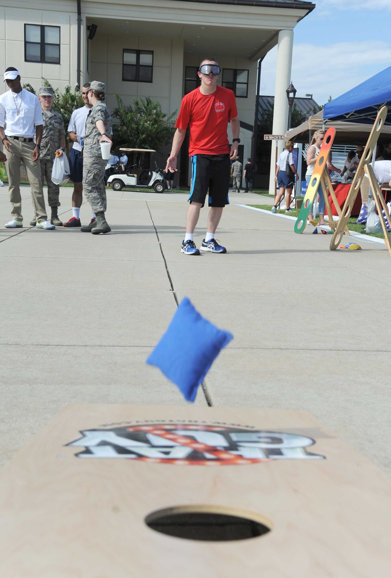 Airman Kevin Polsean, 336th Training Squadron, plays corn hole while wearing drunk goggles at the Alcohol Drug Abuse Prevention and Treatment booth during the Air Force’s 67th birthday celebration Sept. 19, 2014, Keesler Air Force Base, Miss. The event also included a cake cutting ceremony, music, games, contests and food.  (U.S. Air Force photo by Kemberly Groue)