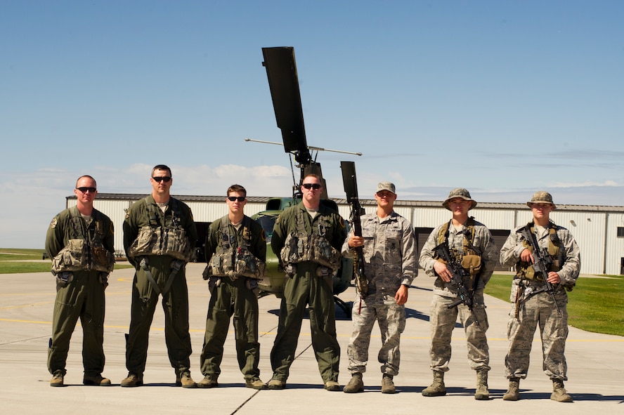 Aircrew members competing in the Global Strike Challenge from the 54th Helicopter Squadron and the tactical response force team from the 91st Security Forces Group, pose for a photo on Minot Air Force Base, N.D., Sept. 3, 2014. The 54th HS team will compete against teams from F.E. Warren AFB, Wyo. and Malmstorm AFB, Mont. for the Bourland Trophy during the Global Strike Challenge.  (U.S. Air Force photo/Senior Airman Brittany Y. Bateman)