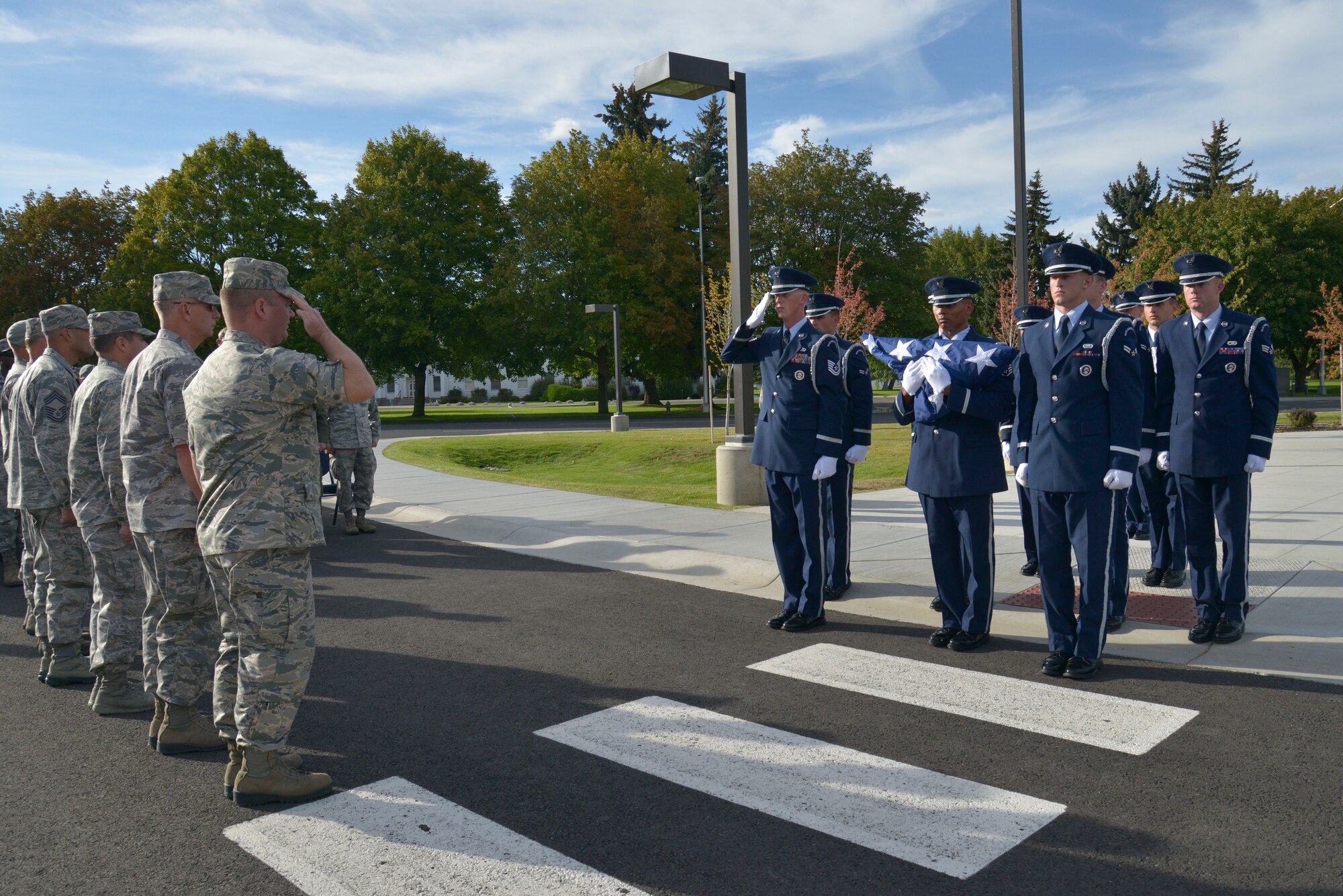 Team Fairchild Honor Guard members prepare to retire a flag during a retreat ceremony honoring prisoners of war and those missing in action at Fairchild Air Force Base, Washington, Sept. 19, 2014. National POW/MIA Recognition Day is a day of observance for all Americans to pause in remembrance of the sacrifices and service of those who were prisoners of war as well as those who are missing in action. (U.S. Air Force photo by Airman 1st Class Janelle Patiño/Released)