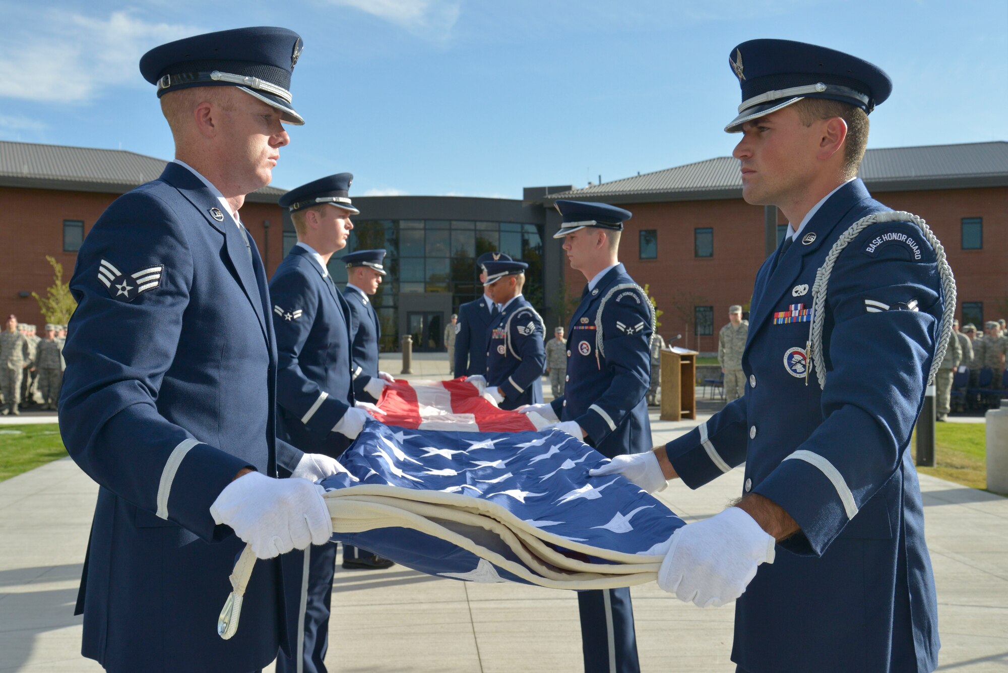 Honor guard members fold the U.S. flag during a retreat ceremony honoring prisoners of war and those missing in action at Fairchild Air Force Base, Washington, Sept. 19, 2014. National POW/MIA Recognition Day is a day of observance for all Americans to pause in remembrance of the sacrifices and service of those who were prisoners of war as well as those who are missing in action. (U.S. Air Force photo by Airman 1st Class Janelle Patiño/Released)