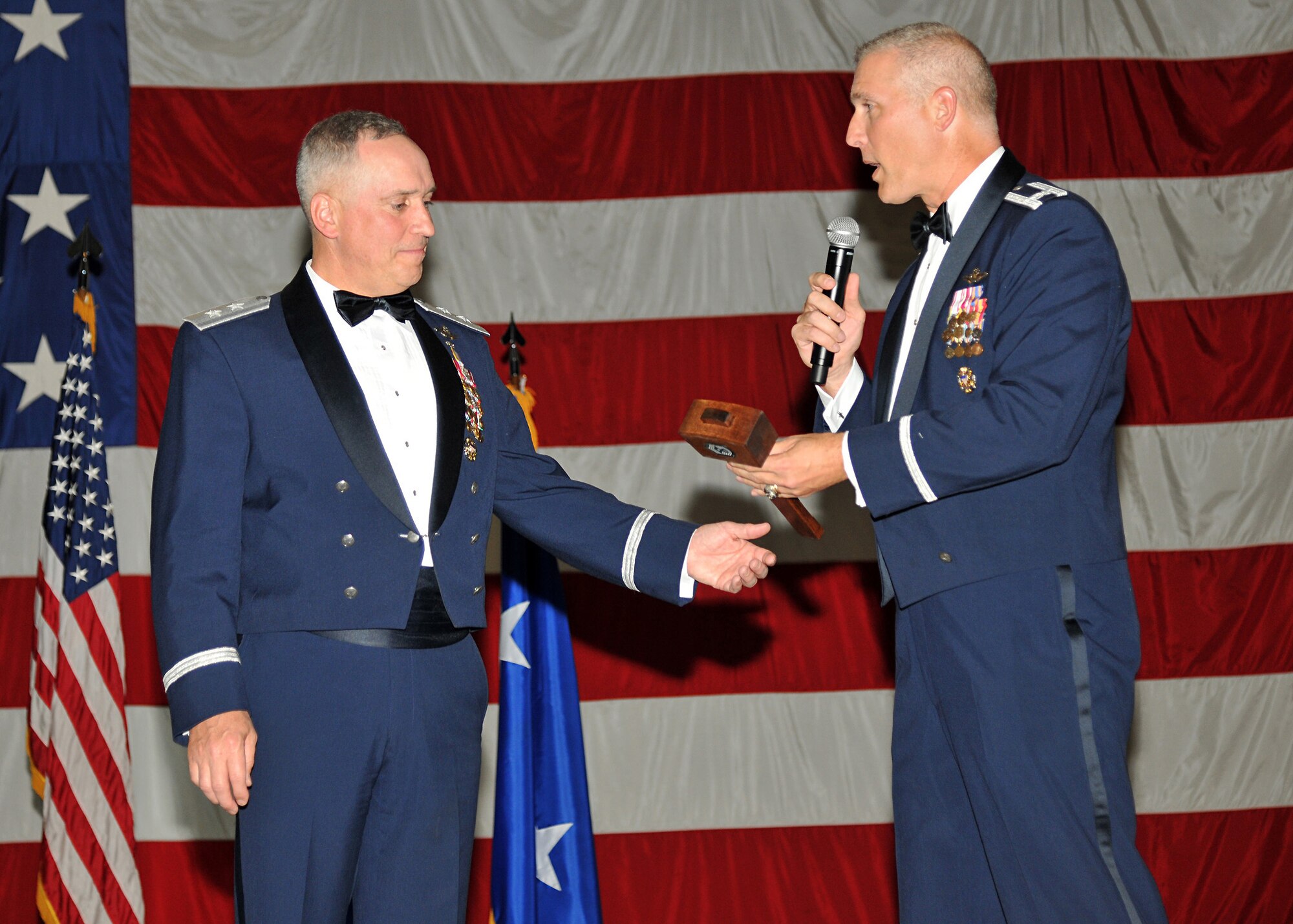 Maj. Gen. Frederick H. “Rick” Martin, U.S. Air Force Expeditionary Center commander, accepts a memento from Col. Paul Bauman, 319th Air Base Wing commander, following Martin’s speech at the  Air Force Ball on Sept. 19, 2014, on Grand Forks Air Force Base, N.D. Martin was the event's keynote speaker. (U.S. Air Force photos/Senior Airman Xavier Navarro)