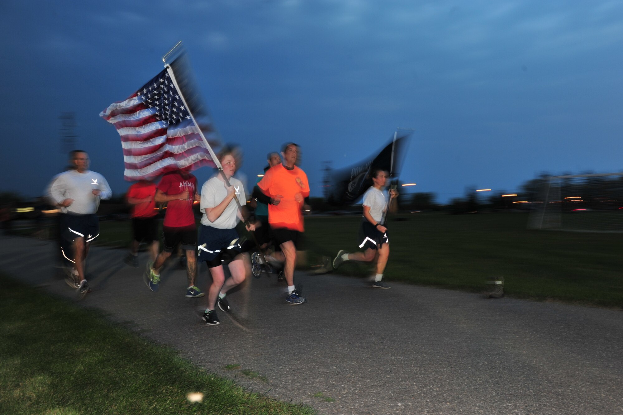 Team Minot Airmen participate in a Prisoners of War and Missing in Action commemoration run on Minot Air Force Base, N.D., Sept. 19, 2014. Volunteers from the 5th Bomb Wing and the 91st Missile Wing ran for 24-hours with the POW/MIA Flag and the U.S. Flag in honor of those held in captivity and those who have yet to return home. (U.S. Air Force photo/Senior Airman Brittany Bateman)