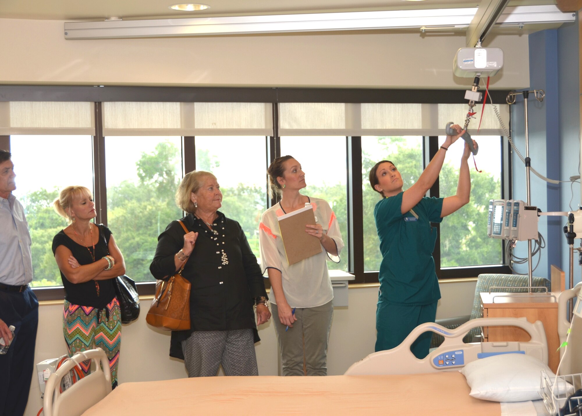 Medical technician Airman 1st Class Nicole Rensberger, 81st Inpatient Operations Squadron, demonstrates a Hoyer lift for members of the Ocean Springs Chamber of Commerce board of directors as she show them the Medical Inpatient Unit.  The group visited Keesler Medical Center Sept. 9 to familiarize them with the patient care the facility offers and future plans for the medical center.  The visitors also had the opportunity to see the Emergency Department, Intensive Care Unit and Cardiac Catheterization Lab. (U.S. Air Force photo by Steve Pivnick)