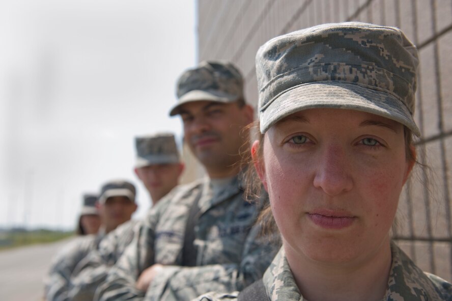 Master Sgt. Erica Robinson, 5th Operations Support Squadron combat crew communications flight chief, poses for a photo with her team on Minot Air Force, N.D., Aug. 04, 2014. The communication crews work Monday through Friday with a 24-hour alert standby roster. (U.S. Air Force photo/Senior Airman Malia Jenkins)