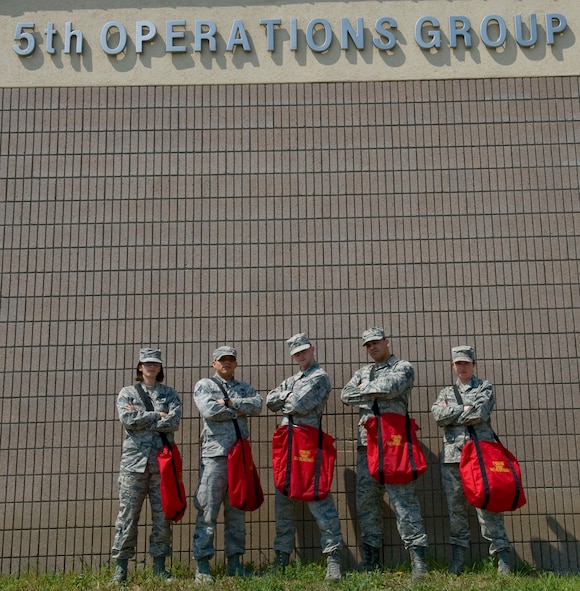 Members from the combat crew communications office pose for a photo on Minot Air Force Base, N.D., Aug. 04, 2014. Their primary responsibility is to train and equip aircrews in the areas of communication security, flight information publications, communications connectivity and friendly aircraft identification. (U.S. Air Force photo/Senior Airman Malia Jenkins)