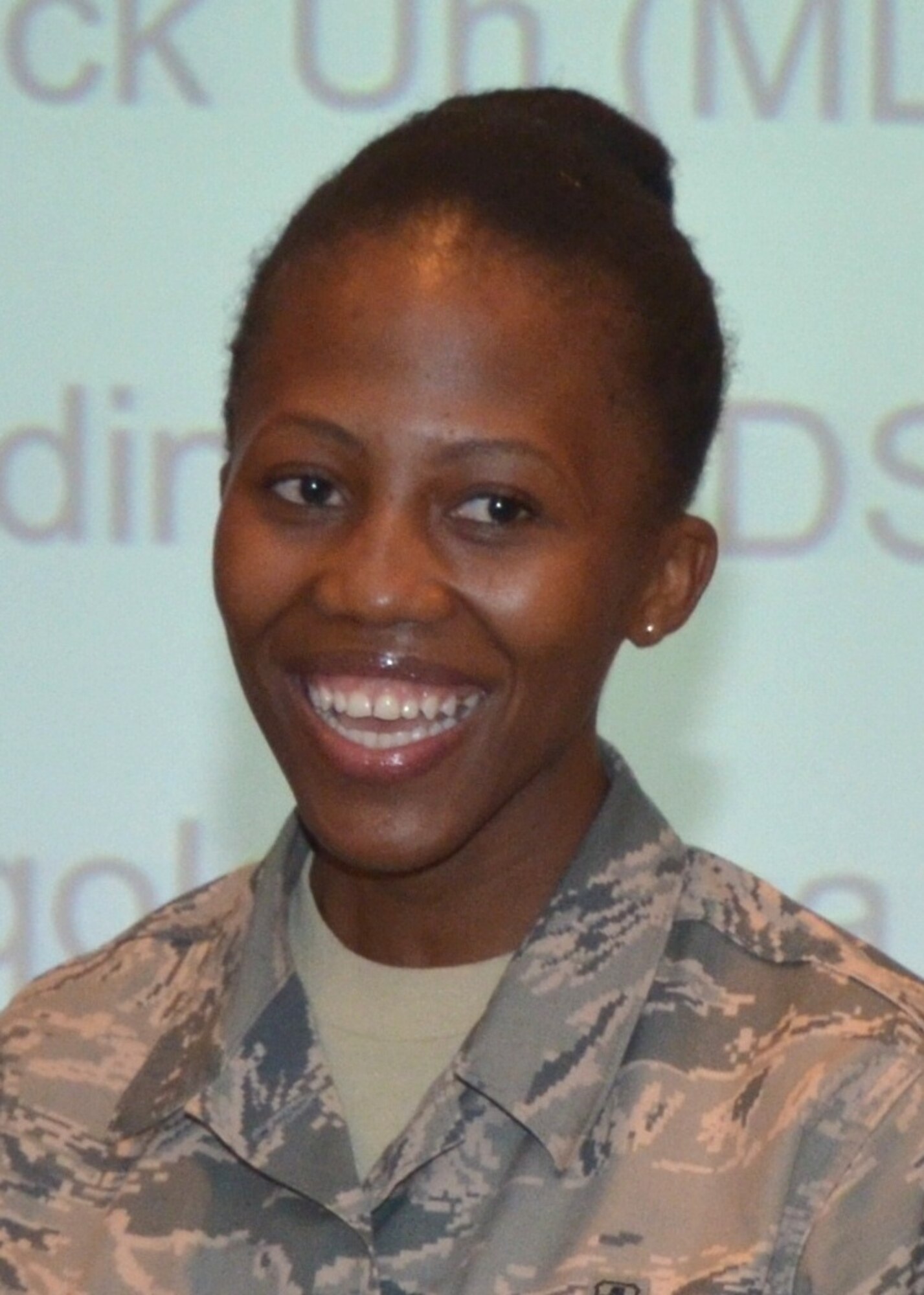 Col. (Dr.) Tom Harrell, 81st Medical Group commander, recognized five “Dragon Medics” for achieving scores of 90 or higher on their Career Development Course end-of-course exams during the Sept. 9 Flight Leaders meeting.  Two of the Airmen were present:  Airmen 1st Class Ayola Mgqolozana (93), pictured, and Yvette Redinger (90).  Both are members of the 81st Dental Squadron.  The other 90+ers were:  Airmen 1st Class  Jessica Dubose (91), 81st Surgical Operations Squadron, and Kapahi Kawai-Puaa (90) and JohnPatrick Uy (92), 81st Diagnostics and Therapeutics Squadron.  A fellow dental squadron member announced to the audience that Mgqolozana, a native of South Africa, had recently become a U.S. citizen.  “I was sworn in on Aug. 15 at the Metarie, La., (federal) office.” Mgqolozana said.
