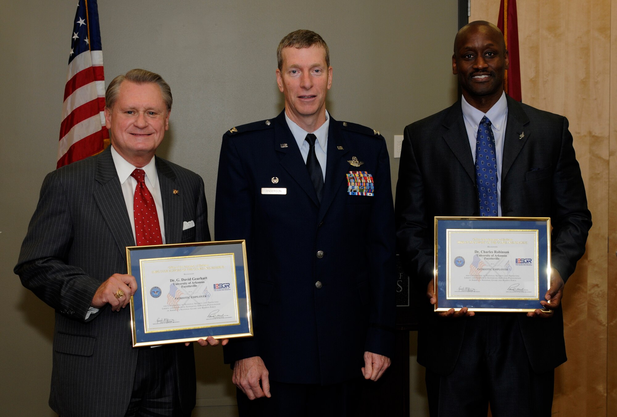 Dr. G. David Gearhart, University of Arkansas (UA) chancellor, left; Col. Mark Anderson, 188th Wing commander, middle; and Dr. Charles F. Robinson, UA vice chancellor for diversity and communication, pose for a photo following an Employer Support of the Guard and Reserve Patriot Award presentation held at the UA Center for Multicultural and Diversity Education in Fayetteville, Arkansas, Sept. 19, 2014. Maj. Danielle Wood, 188th Wing Equal Opportunity chief, recognized the UA, Gearhart and Robinson for their support of her Air National Guard career during the event. Dr. Wood is also the UA Office of Equal Opportunity & Compliance director. (U.S. Air National Guard photo by Maj. Heath Allen/Released)