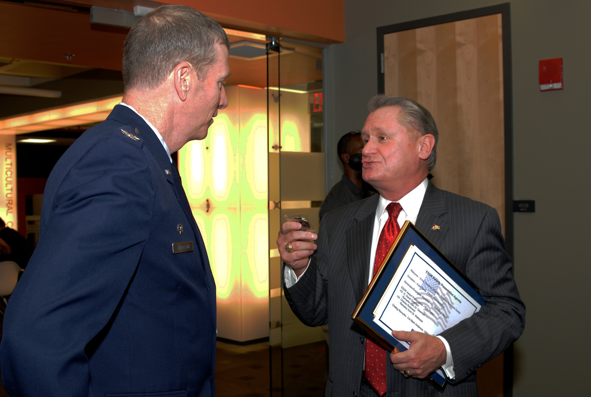 Col. Mark Anderson, 188th Wing commander, speaks with Dr. G. David Gearhart, University of Arkansas (UA) chancellor following an Employer Support of the Guard and Reserve Patriot Award presentation held at the UA Center for Multicultural and Diversity Education in Fayetteville, Arkansas, Sept. 19, 2014. Maj. Danielle Wood, 188th Wing Equal Opportunity chief, recognized the UA, Gearhart and Dr. Charles F. Robinson for their support of her Air National Guard career during the event. Dr. Wood is also the UA Office of Equal Opportunity & Compliance director. (U.S. Air National Guard photo by Maj. Heath Allen/Released)