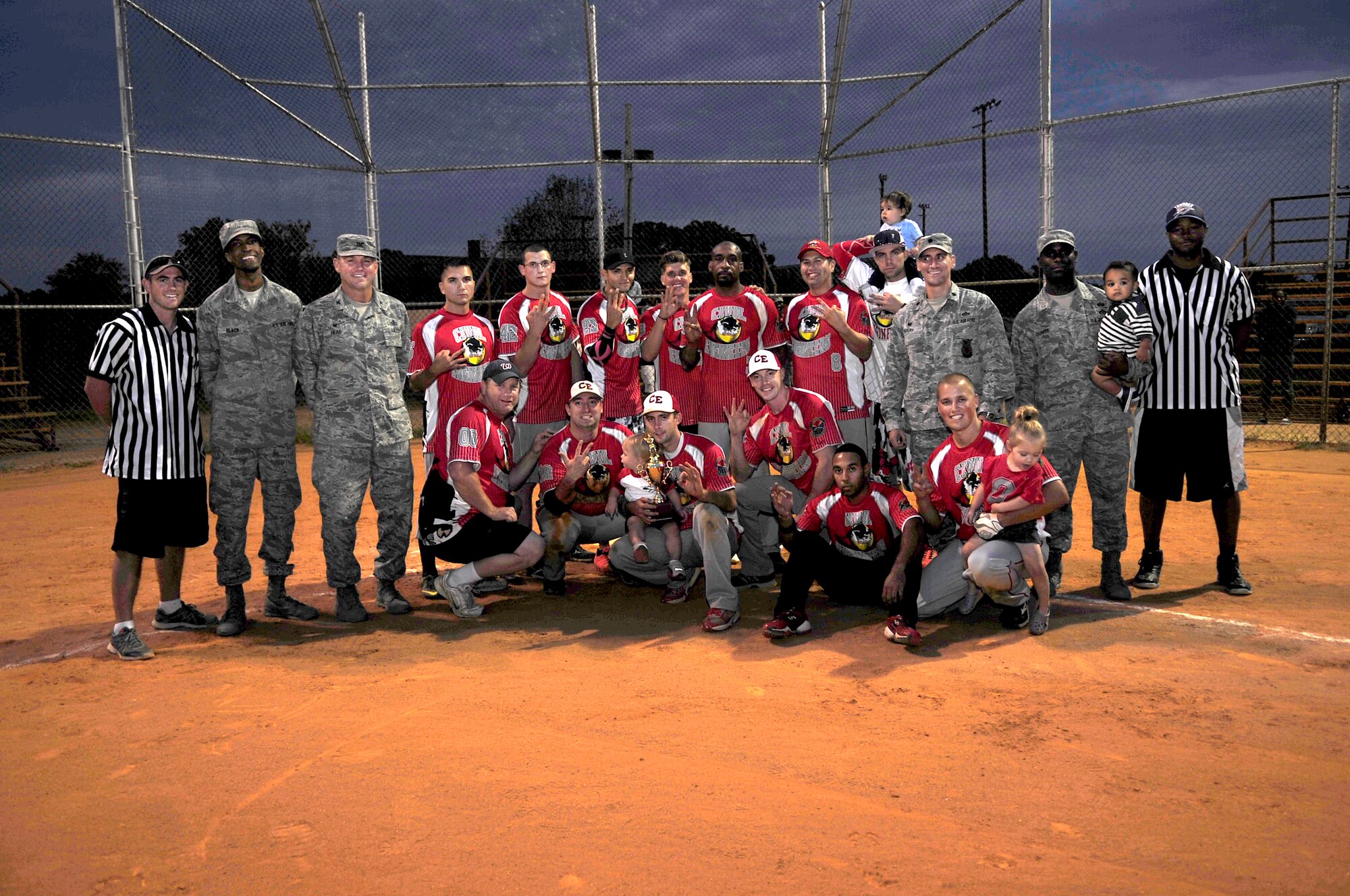 Members of the 633rd Civil Engineering Squadron and U.S. Service members celebrate a win after the Intramural Softball Championship at Langley Air Force Base, Va., Sept. 18, 2014. After seven innings, the 633rd CES team won the championship, 25 to 18. (U.S. Air Force photo by Airman 1st Class Breonna Veal/Released)