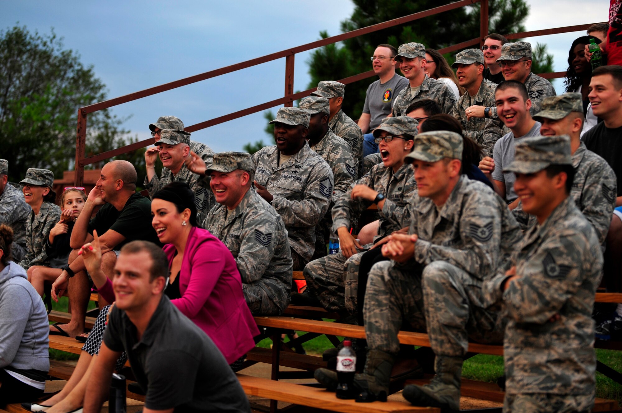 U.S. Air Force Airmen and family members cheer during the Intramural Softball Championship at Langley Air Force Base, Va., Sept. 18, 2014. Many Airmen came out to the championship to show support for their respective squadron teams. (U.S. Air Force photo by Airman 1st Class Breonna Veal/Released)