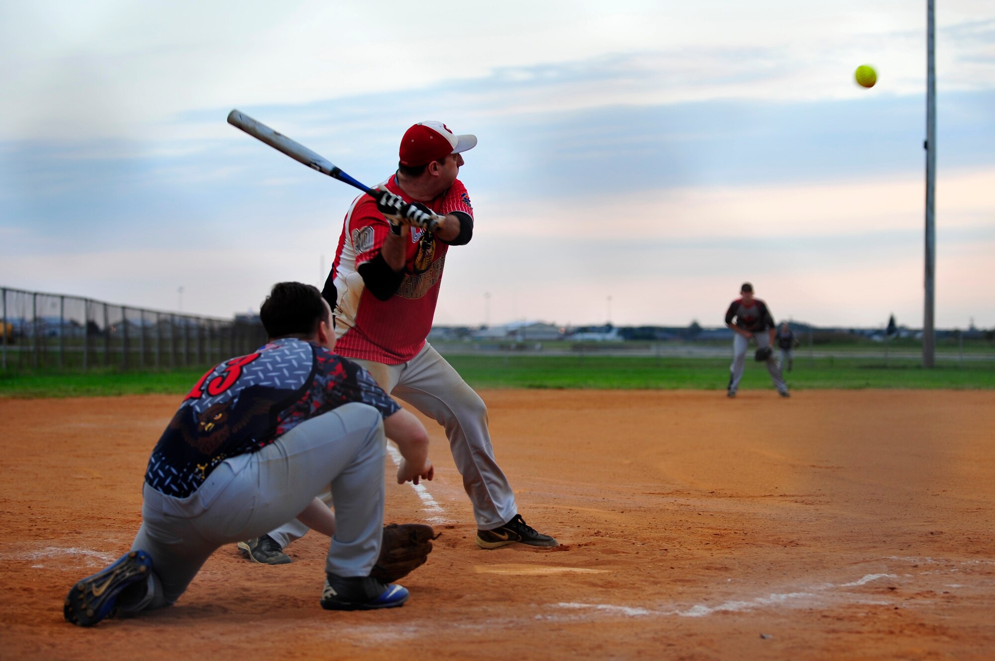 U.S. Air Force Tech. Sgt. Nathan Sechrist, 633rd Civil Engineer Squadron batter, swings at a softball during the Intramural Softball Championship at Langley Air Force Base, Va., Sept. 18, 2014. When not playing softball, the 633rd CES designs, constructs, maintains, repairs and protects 648 facilities and 3,644 acres, to support 151,000 active-duty military members, civilians and retirees, and $3.4 billion in mission assets.  (U.S. Air Force photo by Airman 1st Class Breonna Veal/Released) 