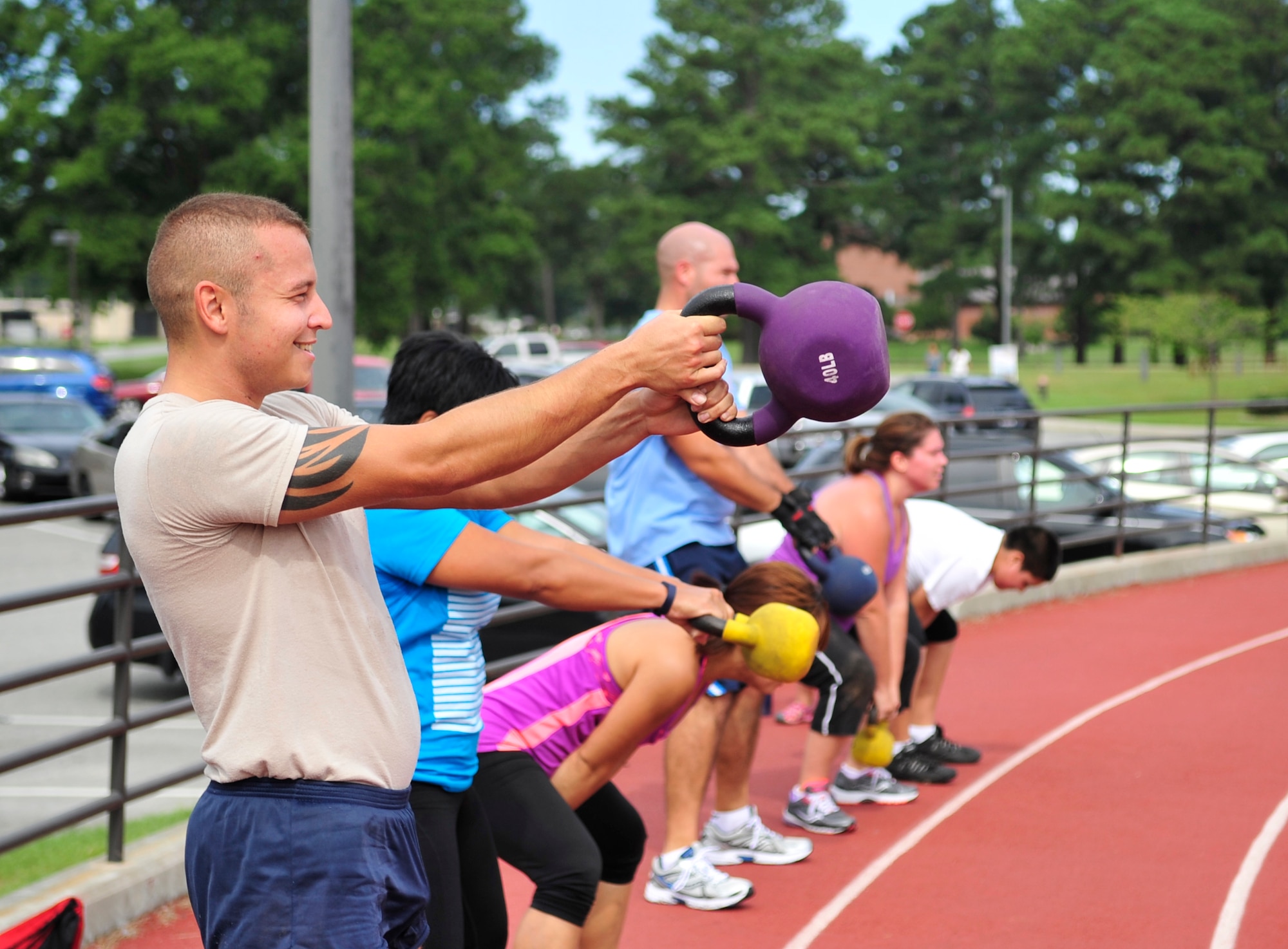 Senior Airman Jordan Melendez, 4th Aircraft Maintenance Squadron avionics specialist, swings a kettle bell during the 2014 Combat Fitness Challenge at Seymour Johnson Air Force Base, North Carolina, Sept. 20, 2014. The Combat Fitness Challenge is an advanced circuit-style fitness course focusing on strength and cardiovascular fitness. (U.S. Air Force photo/Airman 1st Class Shawna L. Keyes)