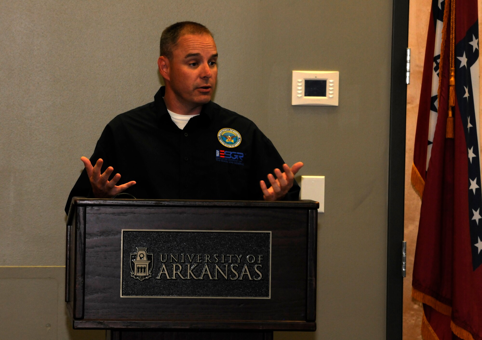 Kyle Fisher with Arkansas Employer Support of the Guard and Reserve addresses a gathering during an Employer Support of the Guard and Reserve Patriot award presentation held at the University of Arkansas Center for Multicultural and Diversity Education in Fayetteville, Arkansas, Sept. 19, 2014. Maj. Danielle Wood, 188th Wing Equal Opportunity chief, recognized her employer and supervisors for their support of her Air National Guard career during the event. Dr. Wood is also the UA Office of Equal Opportunity & Compliance director. (U.S. Air National Guard photo by Maj. Heath Allen/Released) 