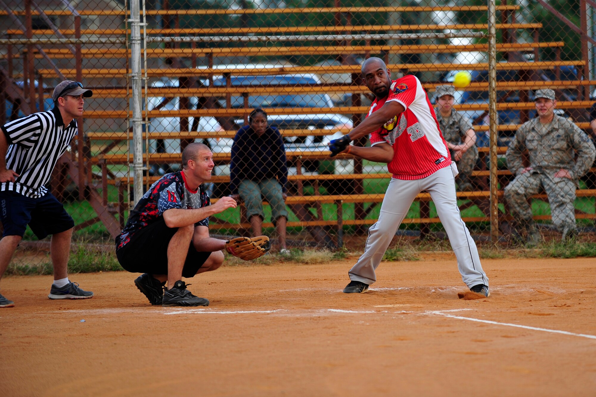 U.S. Air Force Staff Sgt. Nathan Hupp, 633rd Civil Engineer Squadron batter, takes a swing at a softball during the Intramural Softball Championship at Langley Air Force Base, Va., Sept. 18, 2014. The 633rd CES team won the championship against the 45th Intelligence Squadron team, 25 to 18. (U.S. Air Force photo by Airman 1st Class Breonna Veal/Released)