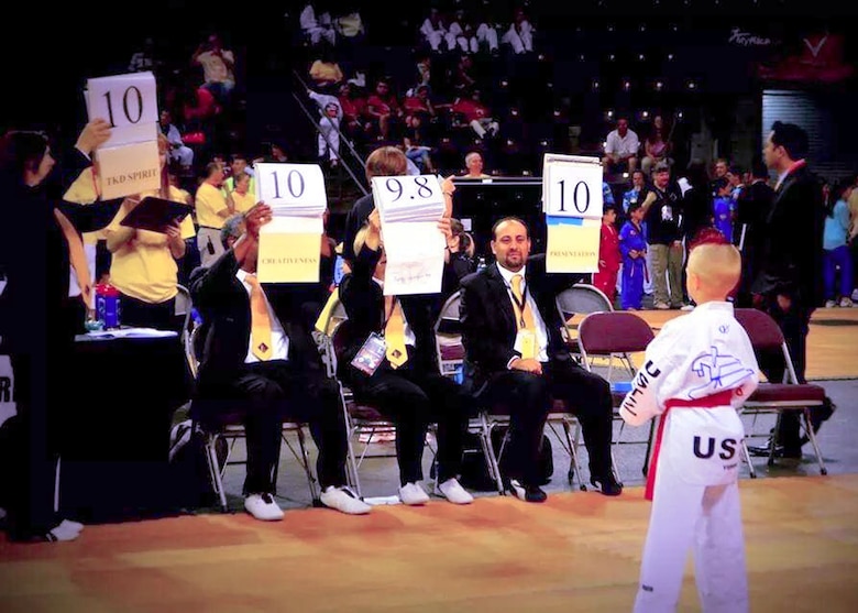 Kelan Wall, 7, son of Master Sgt. Stephen Wall, 43rd Logistics Readiness Squadron, receives an almost perfect score from the judges during the creative breaking event at the 6th annual U.S. Open Taekwondo Hanmadang competition in Colorado Springs, Colorado. After months of training, Kelan and his father, Master Sgt. Stephen Wall, 43rd Logistics Readiness Squadron, won gold medals in the three events he competed in, creative and power breaking and traditional forms. Kelan competed in four events and won gold medals in creative breaking and forms, a silver medal in traditional pairs and a bronze medal in traditional forms. There were a total of 1,600 competitors from 26 states and South Korea in this year’s two-day competition. (Courtesy photo/Melissa Wall)