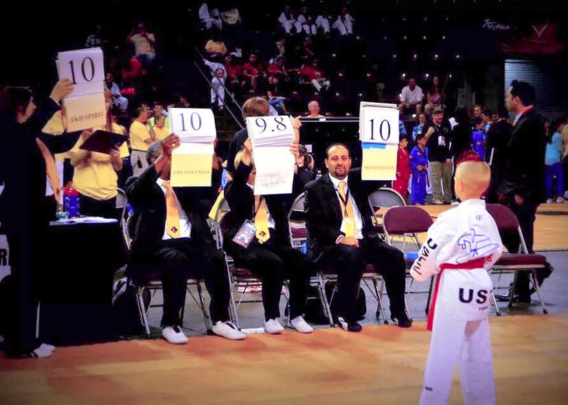 Kelan Wall, 7, son of Master Sgt. Stephen Wall, 43rd Logistics Readiness Squadron, receives an almost perfect score from the judges during the creative breaking event at the 6th annual U.S. Open Taekwondo Hanmadang competition in Colorado Springs, Colorado. After months of training, Kelan and his father, Master Sgt. Stephen Wall, 43rd Logistics Readiness Squadron, won gold medals in the three events he competed in, creative and power breaking and traditional forms. Kelan competed in four events and won gold medals in creative breaking and forms, a silver medal in traditional pairs and a bronze medal in traditional forms. There were a total of 1,600 competitors from 26 states and South Korea in this year’s two-day competition. (Courtesy photo/Melissa Wall)