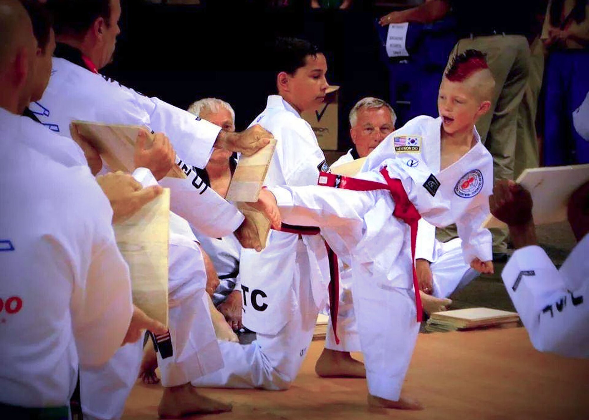 Kelan Wall, 7, son of Master Sgt. Stephen Wall, 43rd Logistics Readiness Squadron, breaks nine boards in a row during the creative breaking event at the 6th annual U.S. Open Taekwondo Hanmadang competition in Colorado Springs, Colorado. After months of training, Kelan and his father, Master Sgt. Stephen Wall, 43rd Logistics Readiness Squadron, won gold medals in the three events he competed in, creative and power breaking and traditional forms. Kelan competed in four events and won gold medals in creative breaking and forms, a silver medal in traditional pairs and a bronze medal in traditional forms. There were a total of 1,600 competitors from 26 states and South Korea in this year’s two-day competition. (Courtesy photo/Melissa Wall)