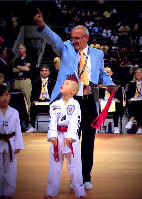 Kelan Wall, 7, son of Master Sgt. Stephen Wall, 43rd Logistics Readiness Squadron, is awarded first place by a judge in the creative forms event at the 6th annual U.S. Open Taekwondo Hanmadang competition in Colorado Springs, Colorado. After months of training, Kelan and his father, Master Sgt. Stephen Wall, 43rd Logistics Readiness Squadron, won gold medals in the three events he competed in, creative and power breaking and traditional forms. Kelan competed in four events and won gold medals in creative breaking and forms, a silver medal in traditional pairs and a bronze medal in traditional forms. There were a total of 1,600 competitors from 26 states and South Korea in this year’s two-day competition. (Courtesy photo/Melissa Wall)
