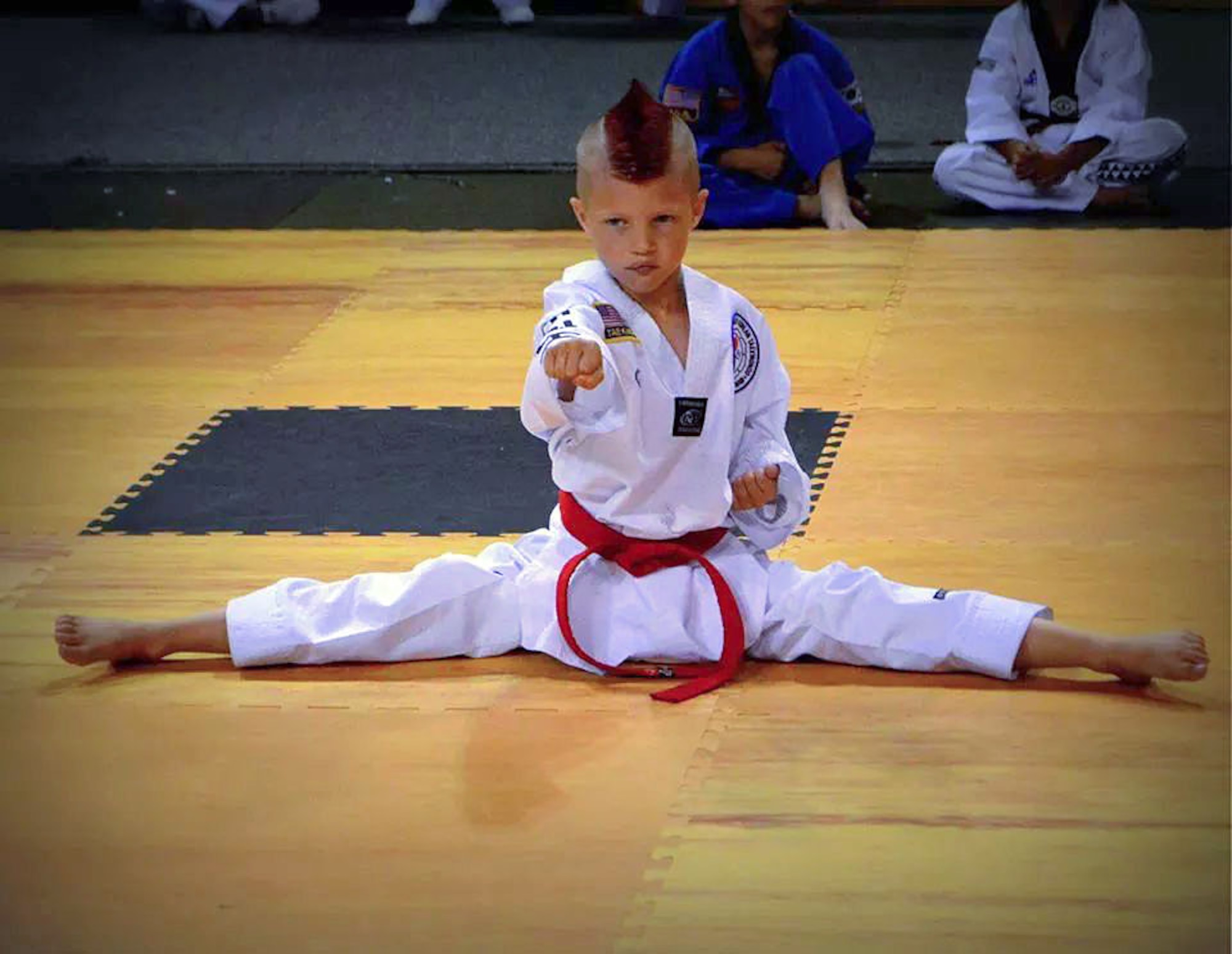 Kelan Wall, 7, son of Master Sgt. Stephen Wall, 43rd Logistics Readiness Squadron, competes at the 6th annual U.S. Open Taekwondo Hanmadang competition in Colorado Springs, Colorado, Kelan and his father, Master Sgt. Stephen Wall, 43rd Logistics Readiness Squadron, won gold medals in the three events he competed in, creative and power breaking and traditional forms. Kelan competed in four events and won gold medals in creative breaking and forms, a silver medal in traditional pairs and a bronze medal in traditional forms. There were a total of 1,600 competitors from 26 states and South Korea in this year’s two-day competition. (Courtesy photo/Melissa Wall)