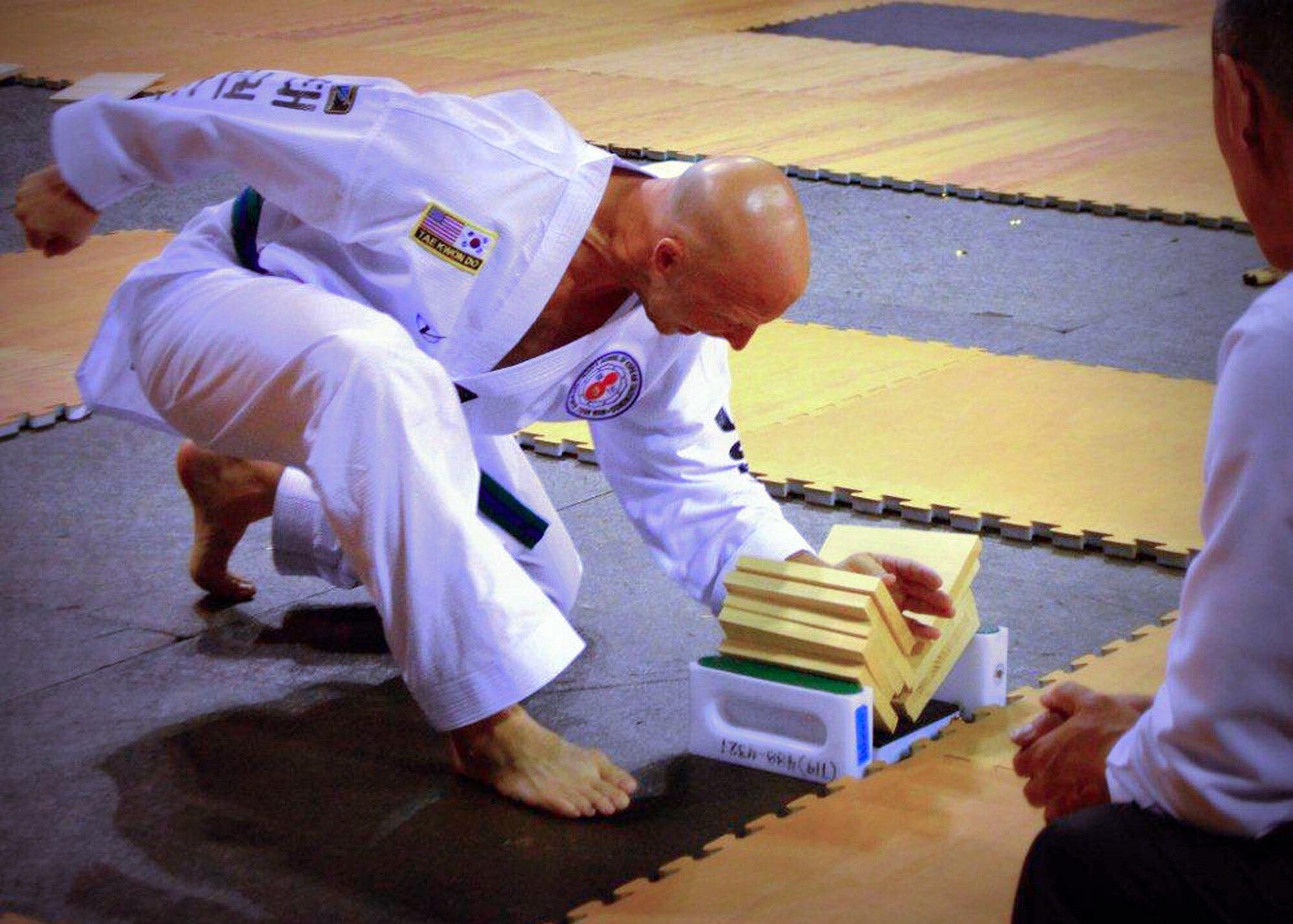 Master Sgt. Stephen Wall, 43rd Logistics Readiness Squadron, breaks five boards during power breaking event at the 6th annual U.S. Open Taekwondo Hanmadang competition in Colorado Springs, Colorado. Wall won gold medals in the three events he competed in, creative and power breaking and traditional forms. His son Kelan, 7, competed in four events and won gold medals in creative breaking and forms, a silver medal in traditional pairs and a bronze medal in traditional forms. There were a total of 1,600 competitors from 26 states and South Korea in this year’s two-day competition. (Courtesy photo/Melissa Wall)