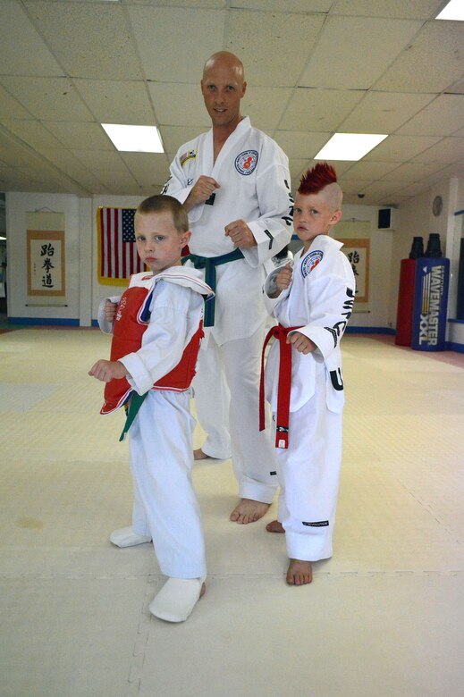 Master Sgt. Stephen Wall, 43rd Logistics Readiness Squadron, poses with his sons Mason, 5, left, and Kelan, 7, at the U.S. Taekwondo Center in Spring Lake, North Carolina before attending the 6th annual U.S. Open Taekwondo Hanmadang competition in Colorado Springs, Colorado. Wall won gold medals in the three events he competed in, creative and power breaking and traditional forms. Kelan competed in four events and won gold medals in creative breaking and forms, a silver medal in traditional pairs and a bronze medal in traditional forms. There were a total of 1,600 competitors from 26 states and South Korea in this year’s two-day competition. (U.S. Air Force photo/Marvin Krause)