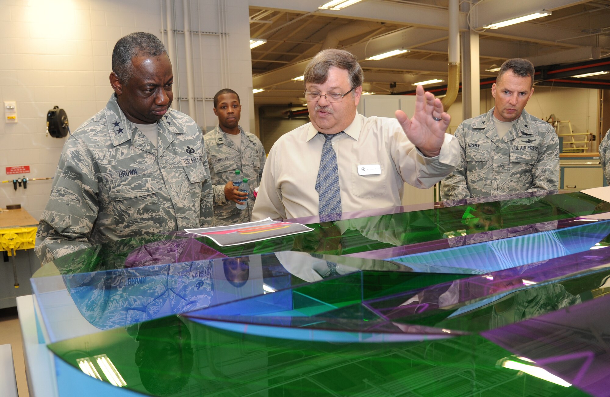 Maj. Gen. Mark Brown, 2nd Air Force commander, is shown a model of the runway by Roland Wilson, 81st Training Support Squadron, which was built by the Trainer Development Facility, during a two-day immersion tour of the base Sept. 16-17, 2014, Keesler Air Force Base, Miss.  The purpose of the tour was to learn the integration of the base’s mission, operations and personnel.  Brown also toured the 81st Medical Group, 81st Mission Support Group and held an all call. (U.S. Air Force photo by Kemberly Groue)