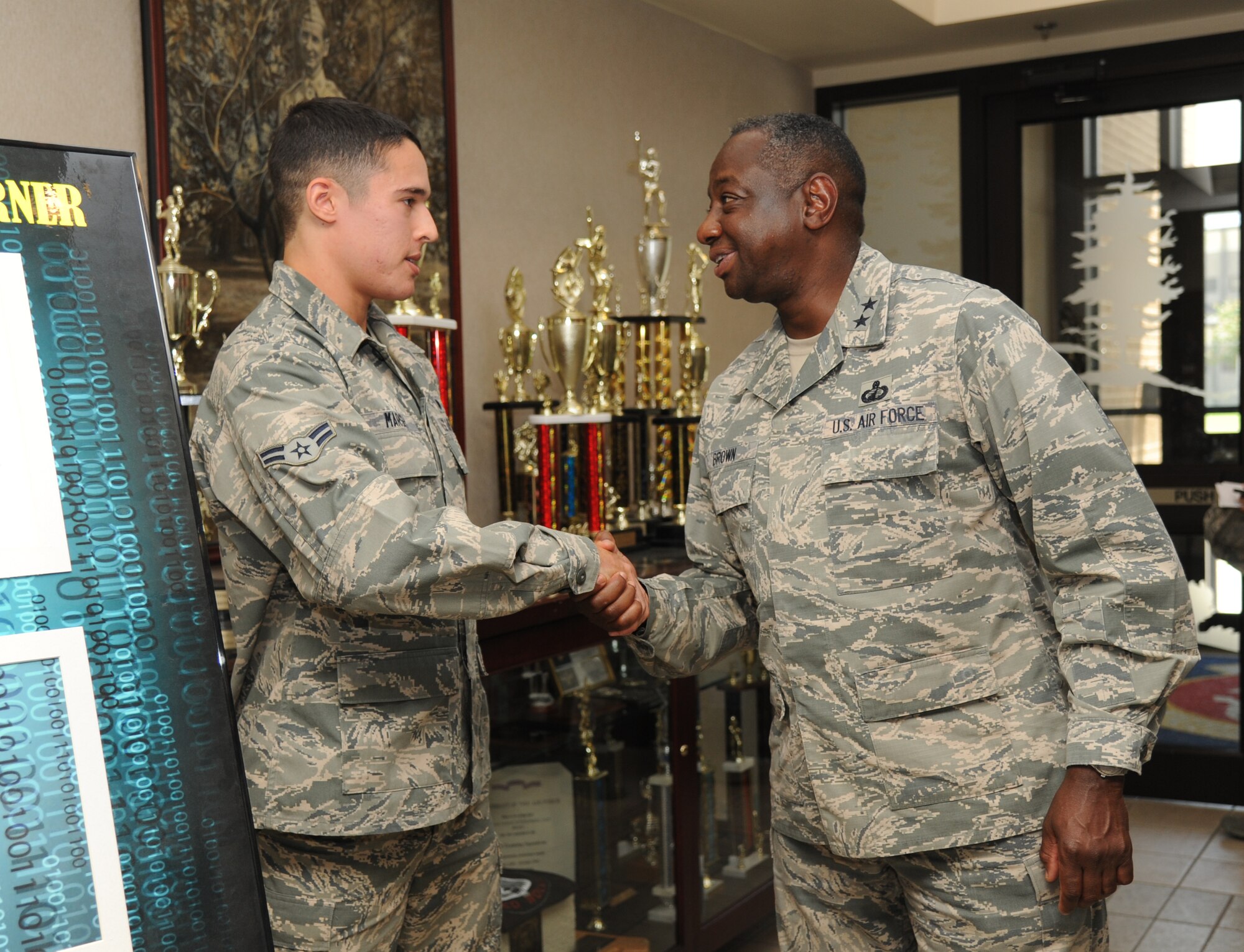 Airman 1st Class Joshua Marsh, 336th Training Squadron, receives a coin from Maj. Gen. Mark Brown, 2nd Air Force commander, following Marsh’s briefing on the “Get it” discipline corner poster at Thomson Hall during a two-day immersion tour of the base Sept. 16-17, 2014, Keesler Air Force Base, Miss.  The purpose of the tour was to learn the integration of the base’s mission, operations and personnel.  Brown also toured the 81st Medical Group, 81st Mission Support Group and held an all call. (U.S. Air Force photo by Kemberly Groue)