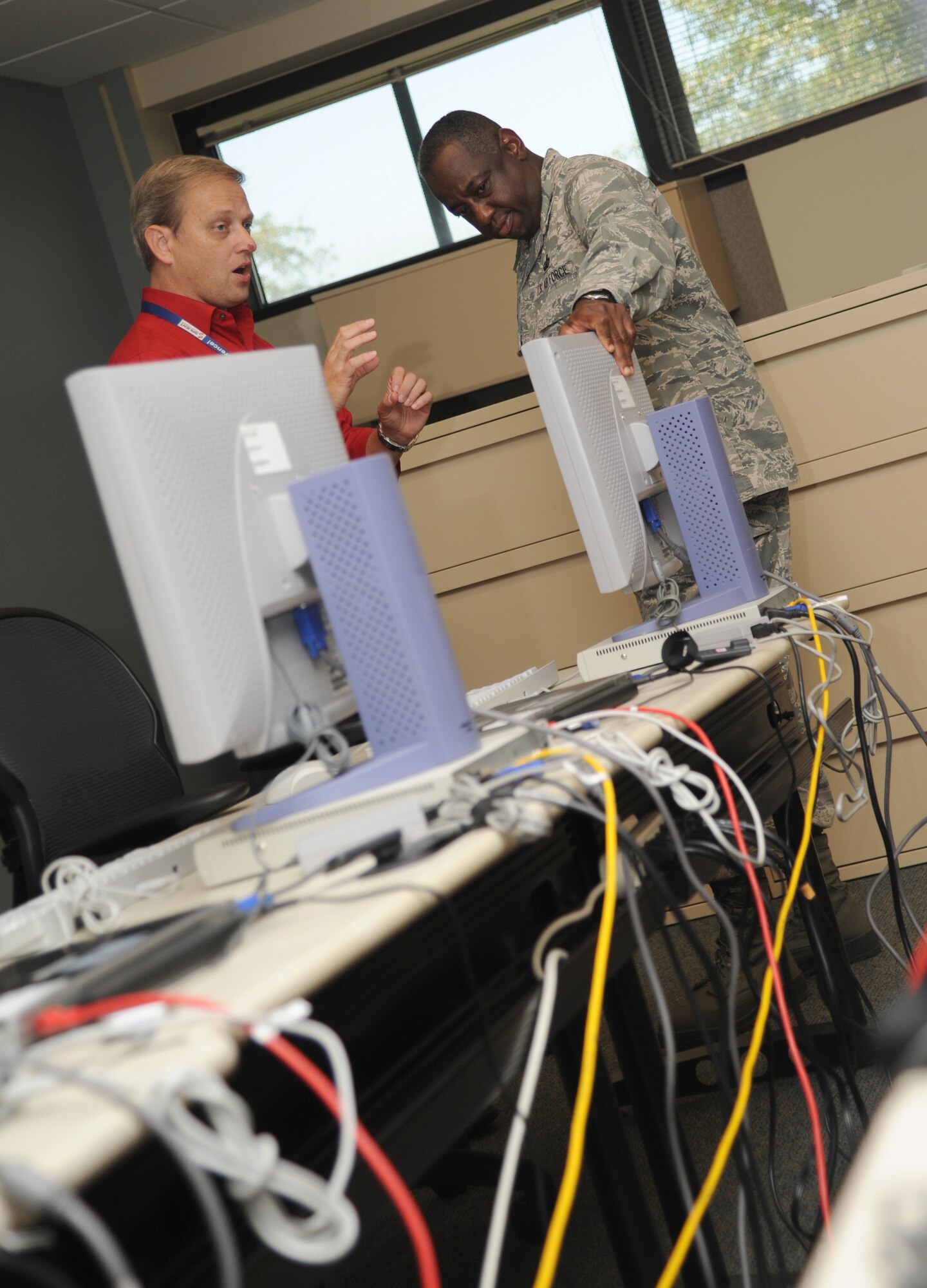 Tim Young, 336th Training Squadron, briefs Maj. Gen. Mark Brown, 2nd Air Force commander, on equipment used for training Airmen in the squadron at Thomson Hall during a two-day immersion tour of the base Sept. 16-17, 2014, Keesler Air Force Base, Miss.  The purpose of the tour was to learn the integration of the base’s mission, operations and personnel.  Brown also toured the 81st Medical Group, 81st Mission Support Group and held an all call. (U.S. Air Force photo by Kemberly Groue)