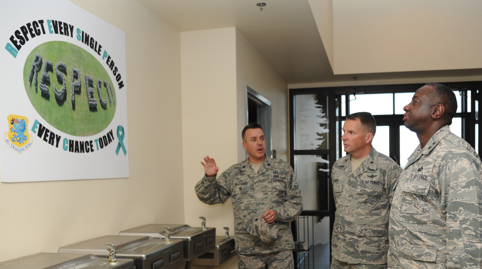 Lt. Col. Jeffrey McLemore, 81st Training Group deputy director, explains the meaning of the “RESPECT” poster to Maj. Gen. Mark Brown, 2nd Air Force commander, far right, as Brig. Gen. Patrick Higby, 81st Training Wing commander, stands by as they tour the 336th Training Squadron at Thomson Hall during a two-day immersion tour of the base Sept. 16-17, 2014, Keesler Air Force Base, Miss.  The purpose of the tour was to learn the integration of the base’s mission, operations and personnel.  Brown also toured the 81st Medical Group, 81st Mission Support Group and held an all call. (U.S. Air Force photo by Kemberly Groue)