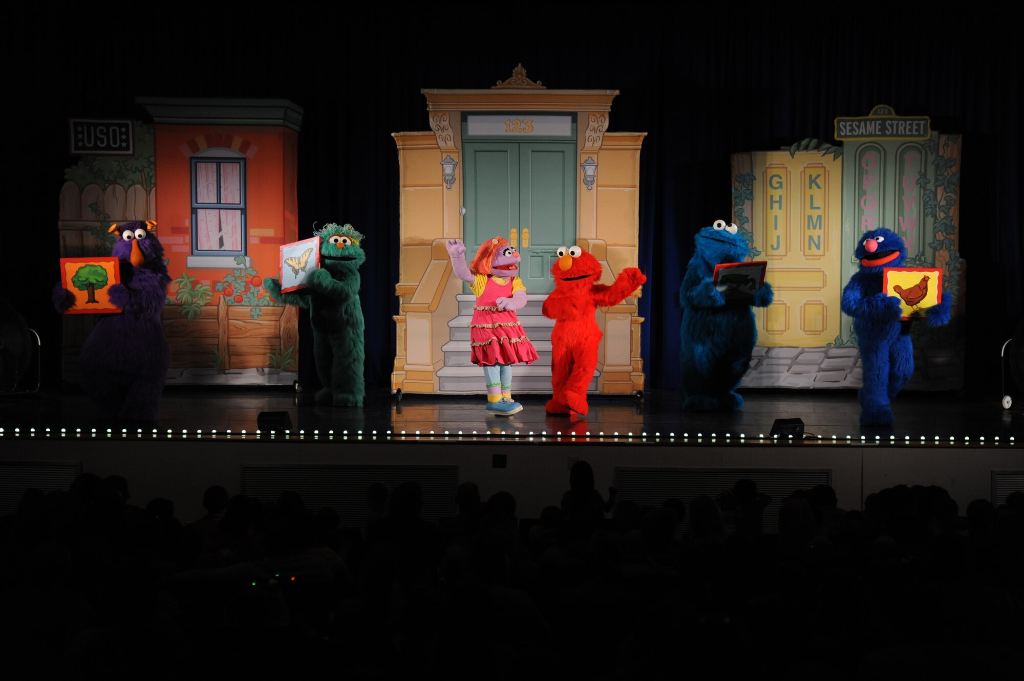 Sesame Street characters perform on stage during the Sesame Street USO Experience for Military Families show Sept. 19, 2014, at the Welch Theater, Keesler Air Force Base, Miss.  The 45-minute family-oriented event hosted by the 81st Force Support Squadron stars a character named Katie who is a military child.  With the help of her Sesame pals, Katie learns to deal with her fears and excitement about relocating.  The show emphasizes the importance of adjusting to change and the power of friendship. (U.S. Air Force photo by Kemberly Groue)