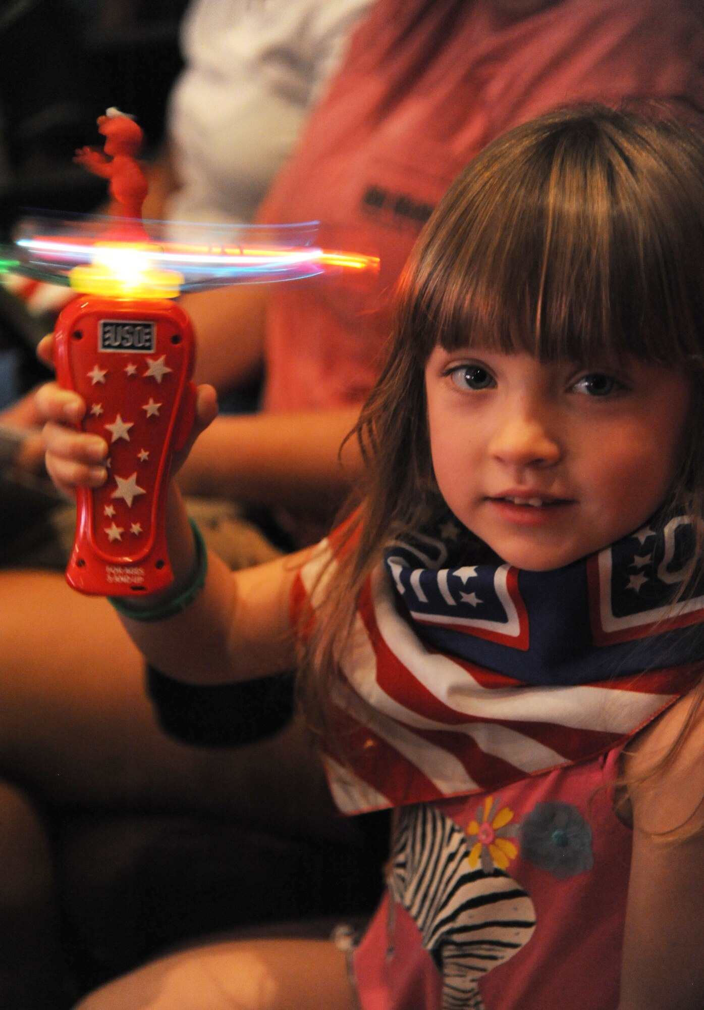 The daughter of Tech. Sgt. Judy Mehaffy, 81st Training Wing, plays with a toy during the Sesame Street USO Experience for Military Families show Sept. 19, 2014, at the Welch Theater, Keesler Air Force Base, Miss.  The 45-minute family-oriented event hosted by the 81st Force Support Squadron stars a character named Katie who is a military child.  With the help of her Sesame pals, Katie learns to deal with her fears and excitement about relocating.  The show emphasizes the importance of adjusting to change and the power of friendship. (U.S. Air Force photo by Kemberly Groue)
