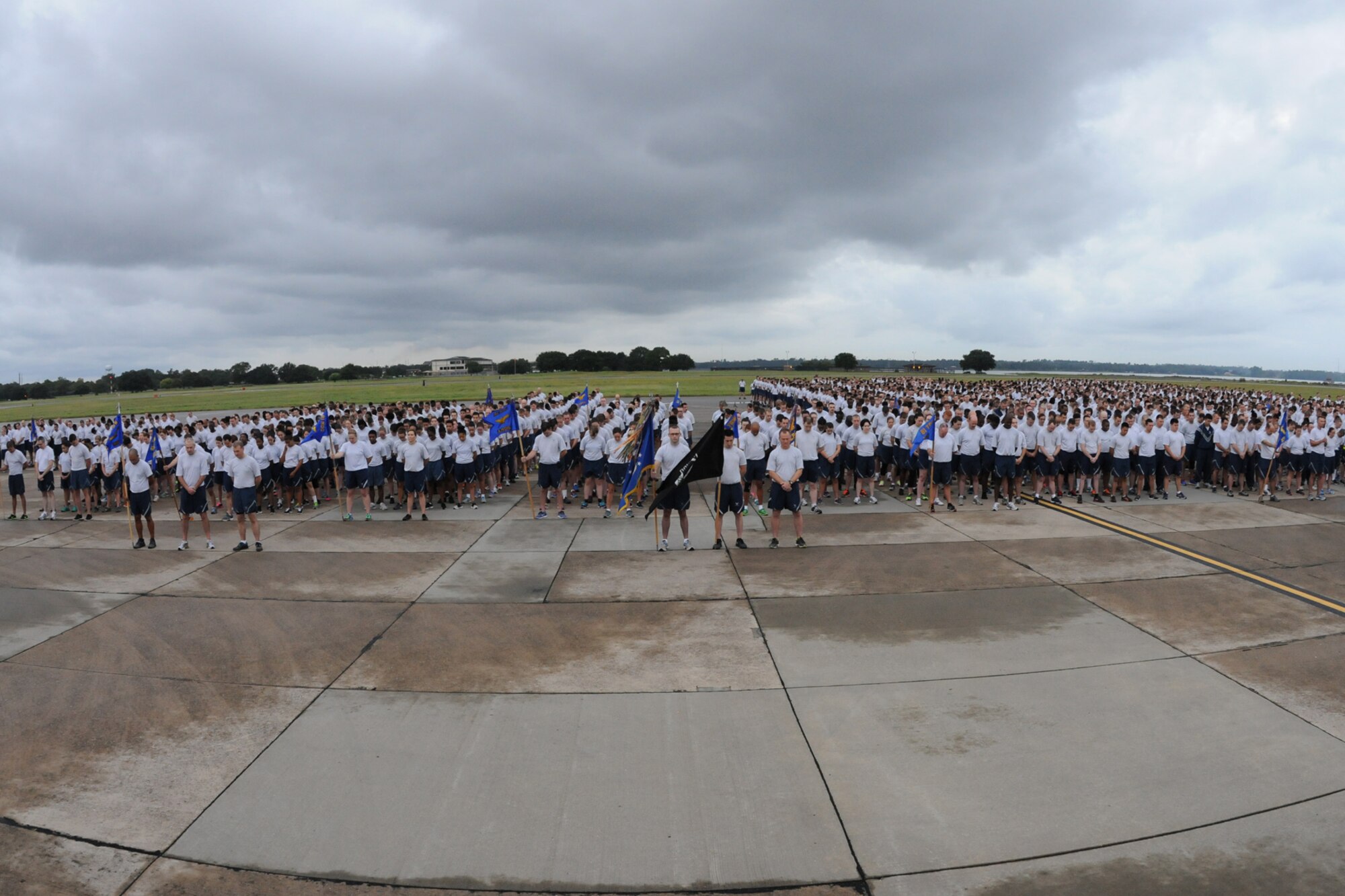 Keesler Airmen lower their heads during an invocation prior to the start of a 5K run on the flight line Sept. 19, 2014.  The run was the kickoff event for a day of activities in support of Wingman Day.  (U.S. Air Force photo by Kemberly Groue)