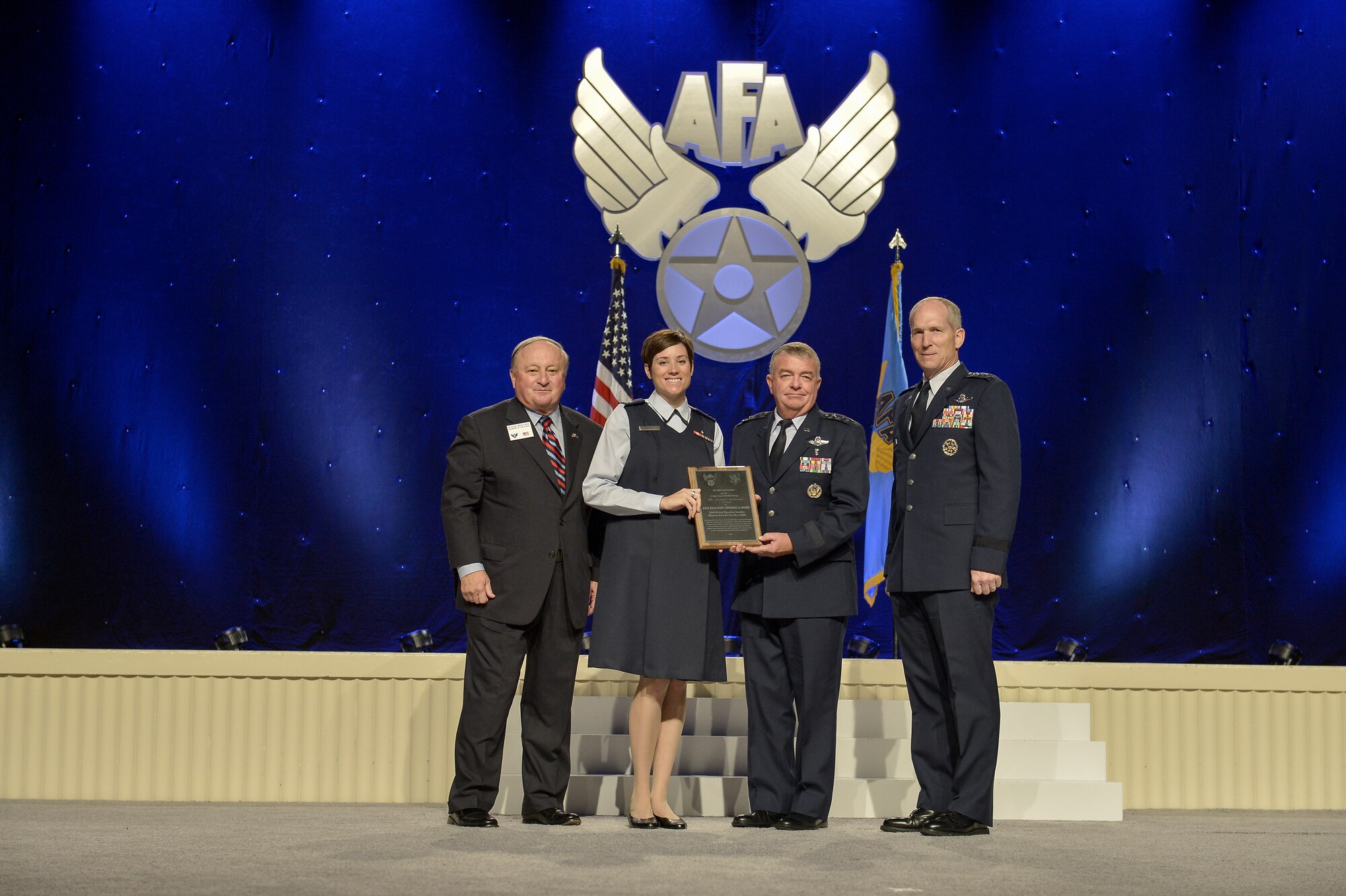Capt. Stephanie Doane, Mountain Home Air Force Base nurse, is awarded the Air Force Association Juanita Redmond Award by George Muellner, AFA Chairman, Lt. Gen. (Dr.) Thomas Travis, Air Force Surgeon General, and Gen. Mike Hostage, Air Combat Command Commander, on Sept. 15, 2014 at the Gaylord Convention Center in National Harbor, Md.  

The Juanita Redmond Award is awarded to an Air Force nurse who has provided a significant contribution to health care of an Air Force individual or family, excellence in clinical nursing or improvment in nursing care.  (Courtesy Photo)