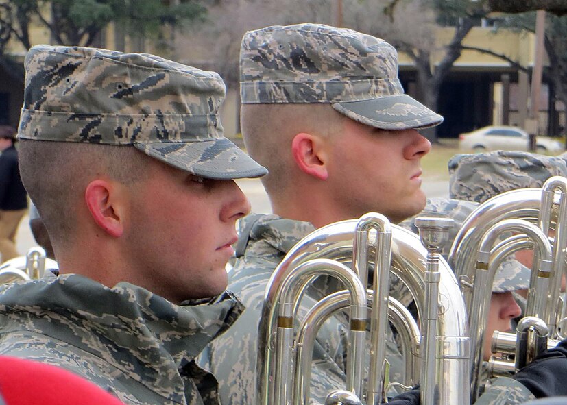 Airman 1st Class Scott Giles, left, 56th Comptroller Squadron customer service technician, holds “trumpet in flight” at Lackland Air Force Base, Texas. Giles now helps new Airmen in-process to Luke Air Force Base as a finance technical advisor. (Courtesy photo)